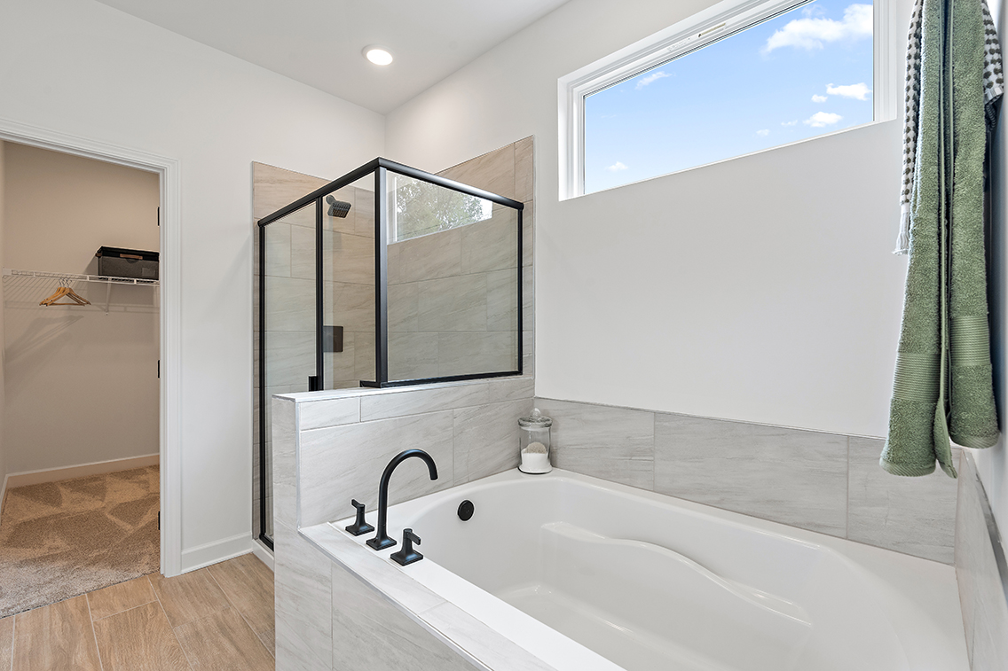 A bathroom with a tub and shower.
