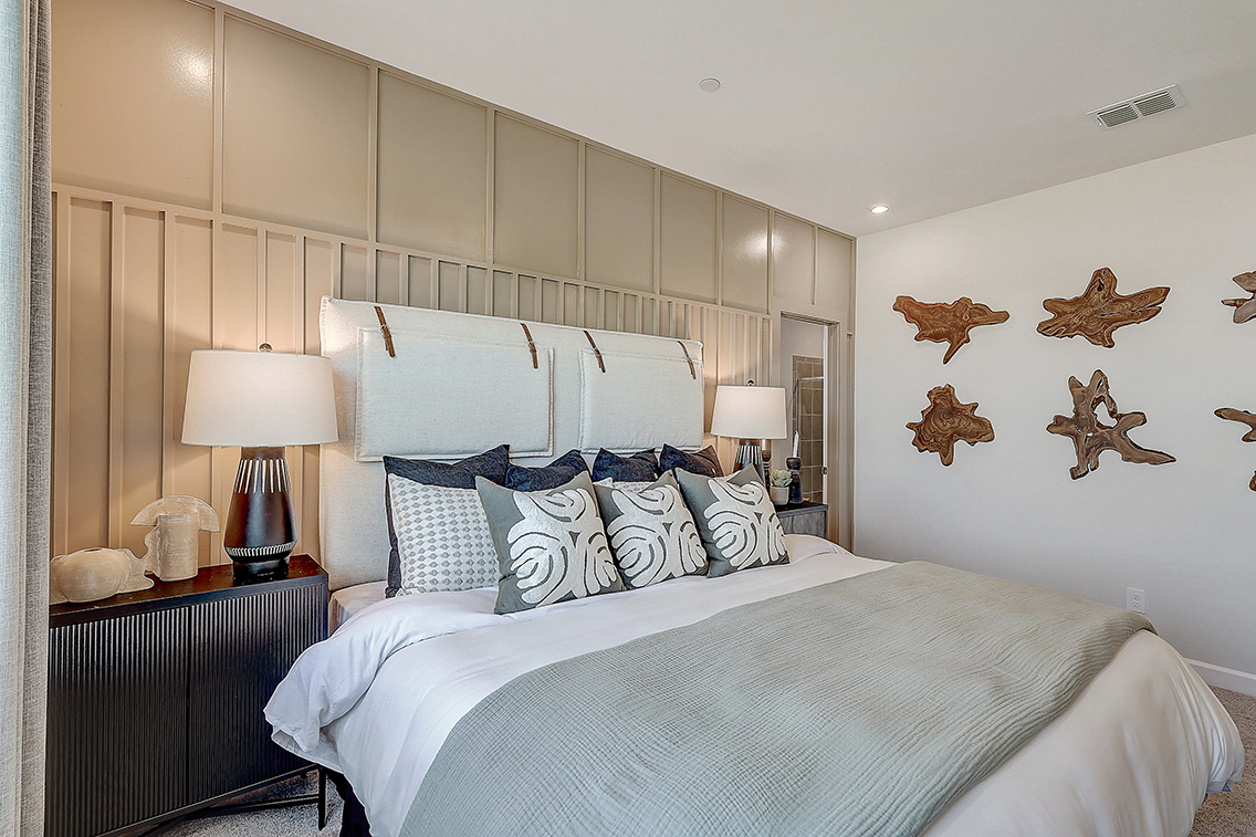 A bed with white sheets.