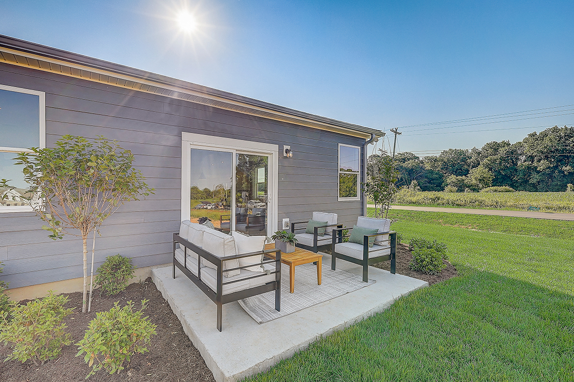 A house with a lawn and a tree.