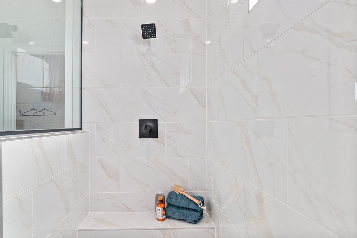 A bathroom with a tile wall.