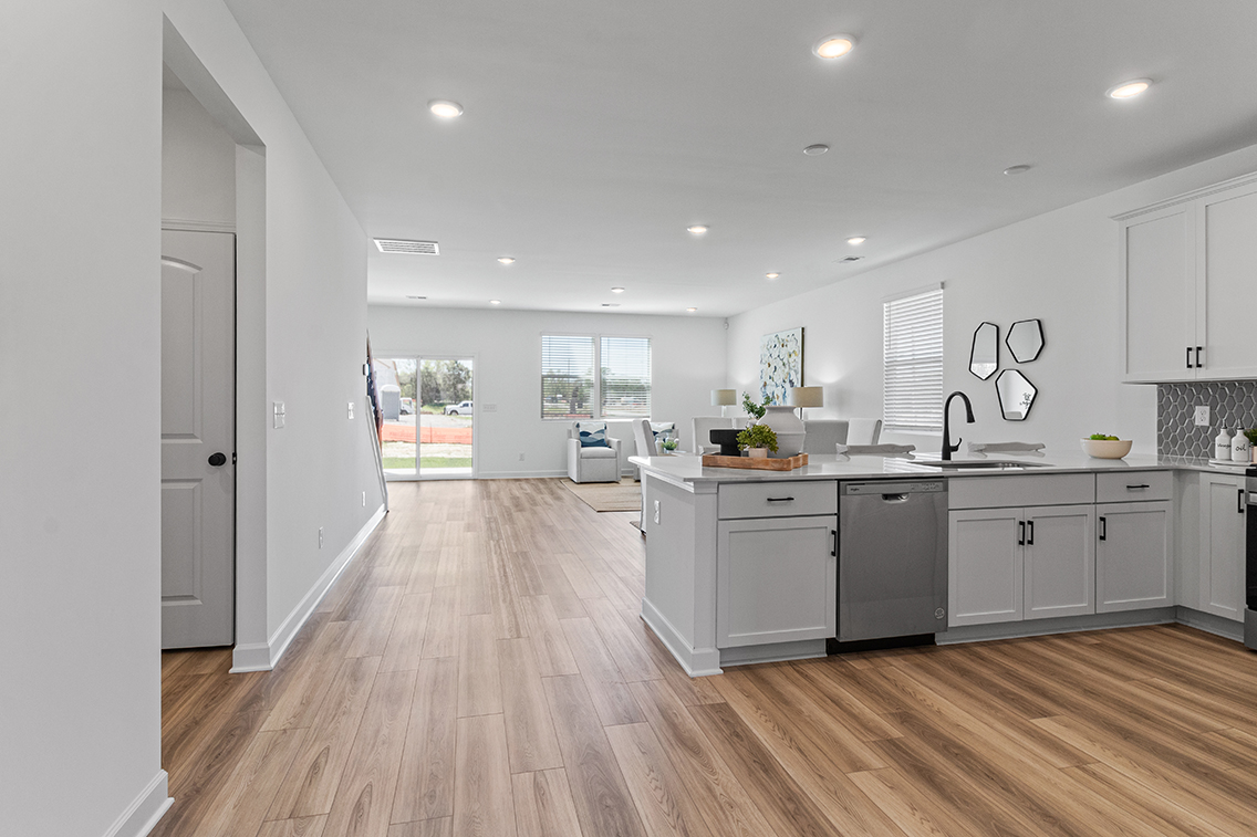 A kitchen with white cabinets.