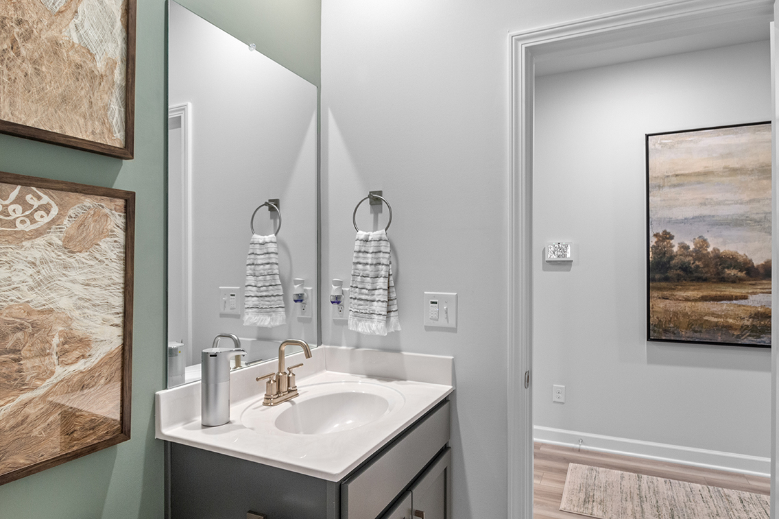 A bathroom with a sink and a mirror.