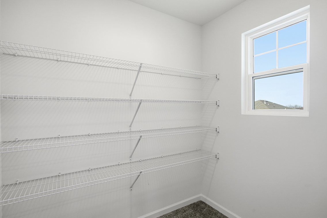 A white wall with a window.