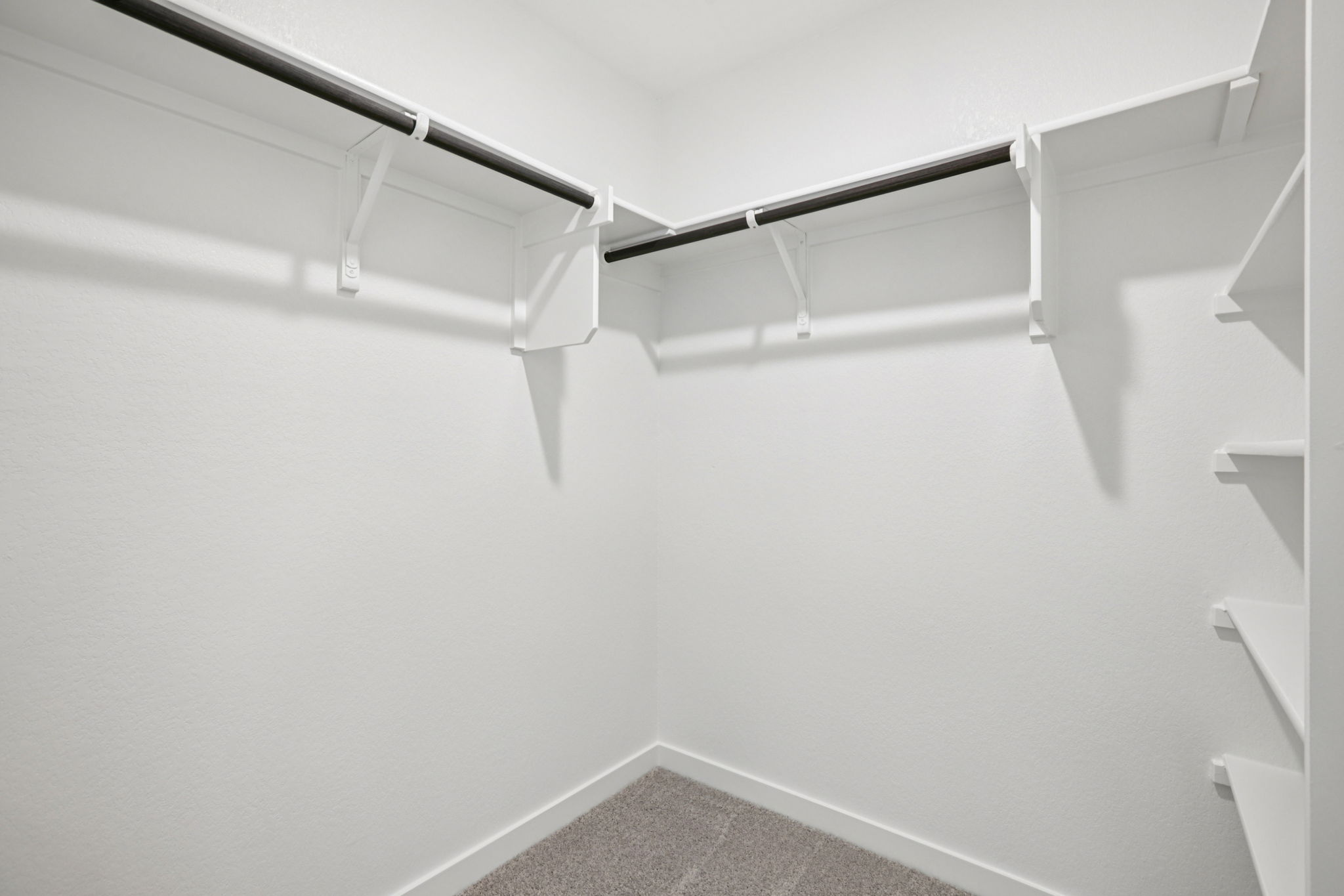 A white staircase with a metal railing.