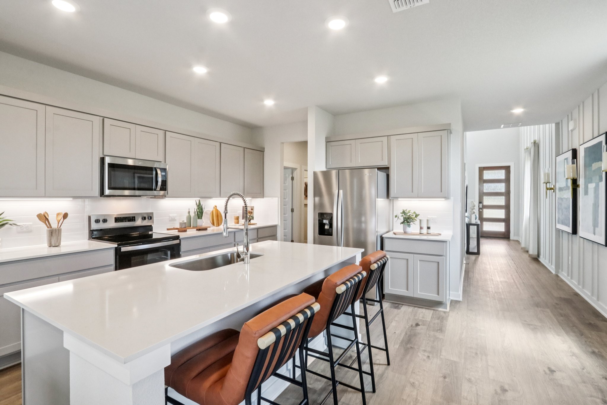 A kitchen with white cabinets.