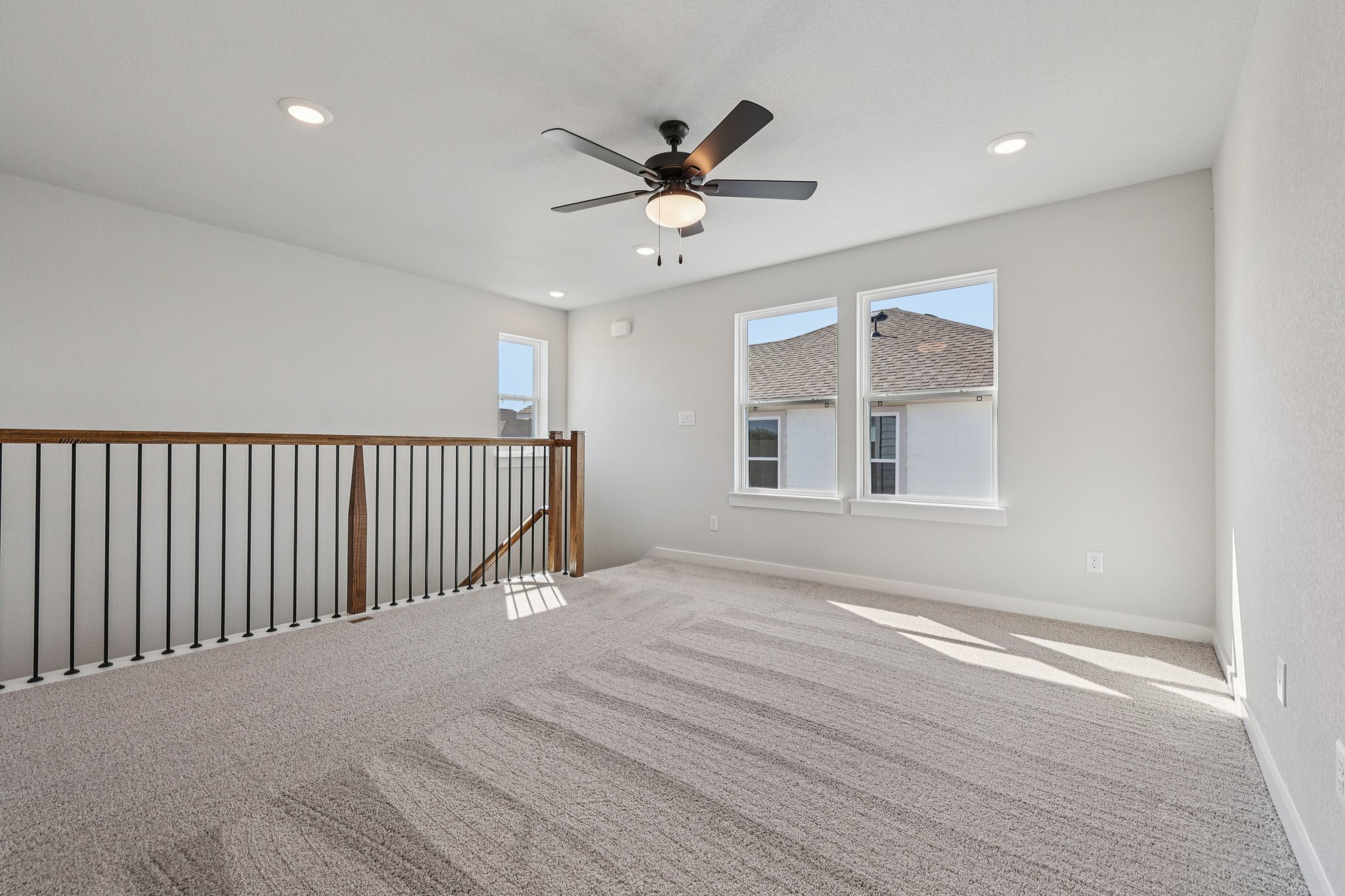 A room with a ceiling fan and a window.