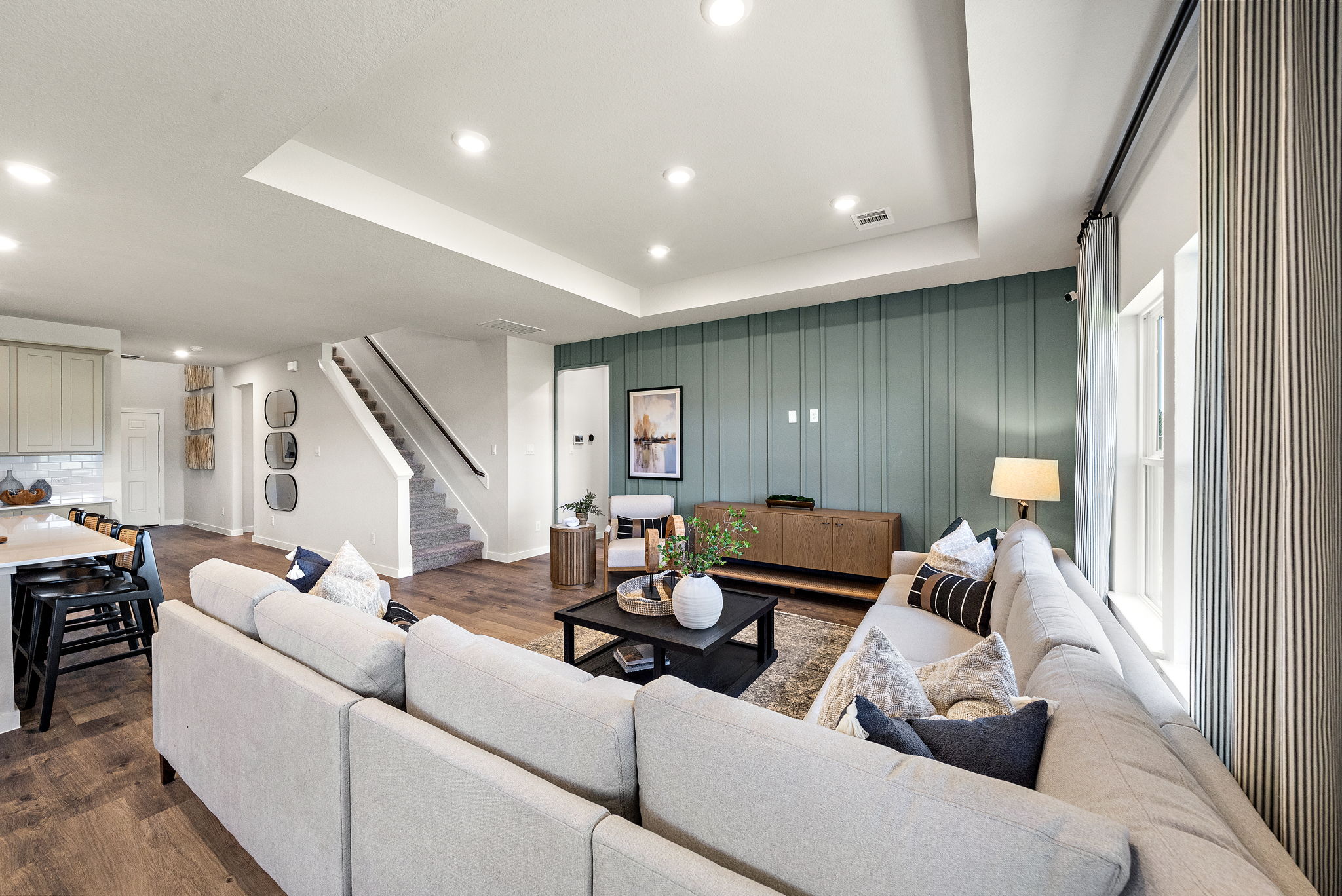 A large living room with a staircase.