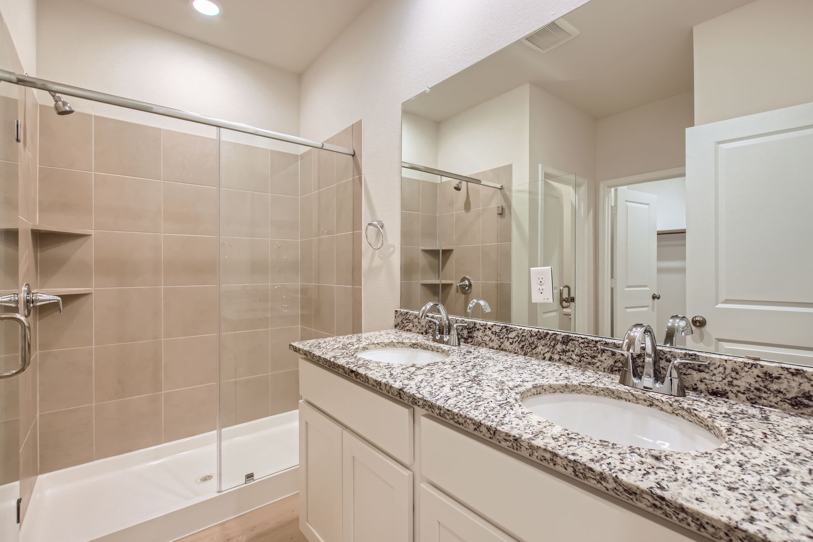A bathroom with a large mirror.