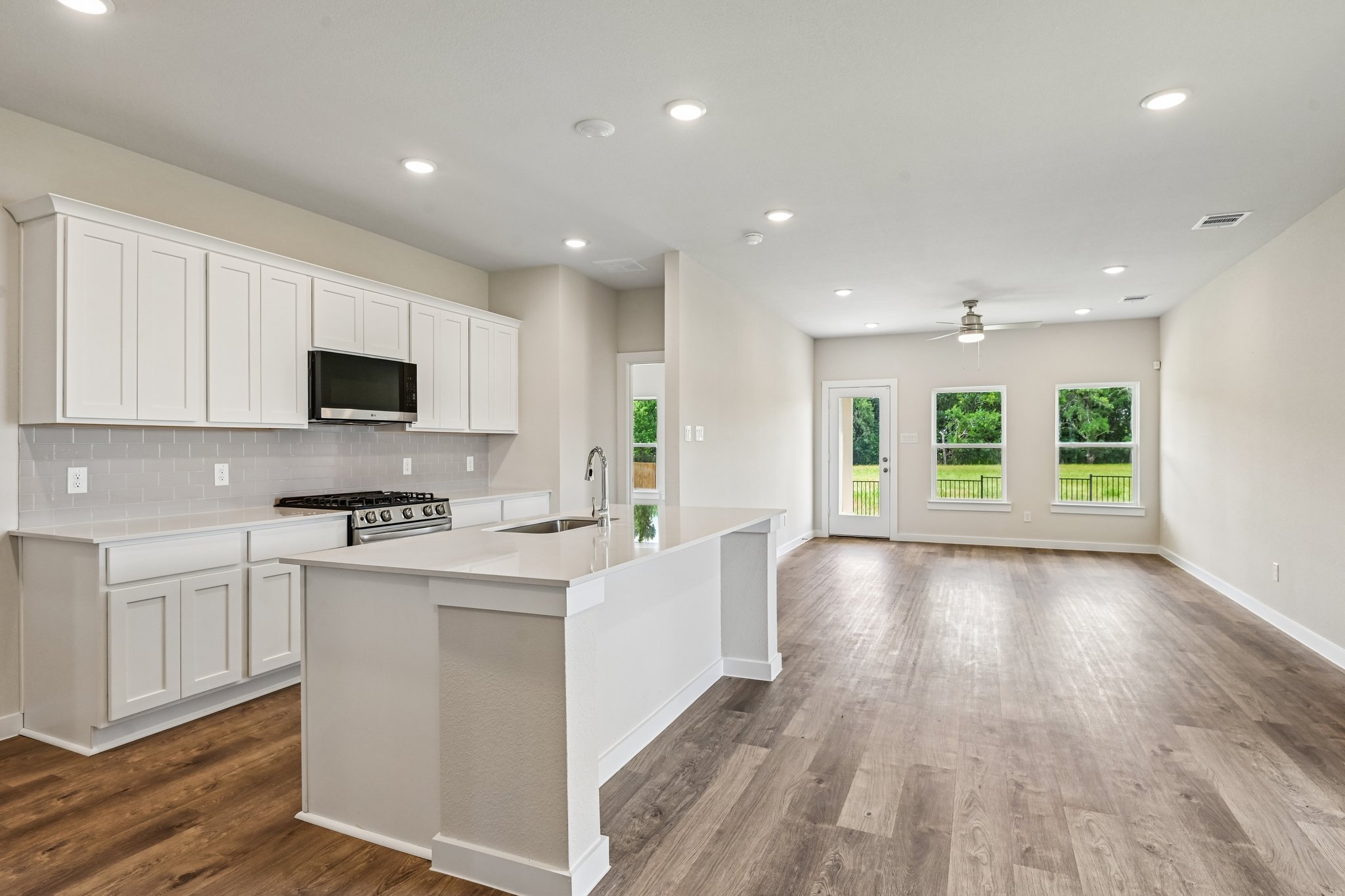 A kitchen with white cabinets.