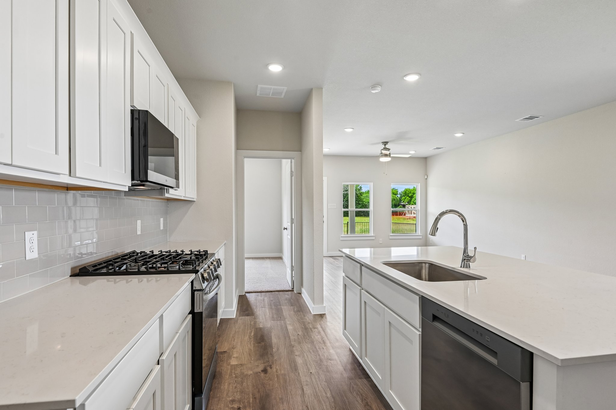 A kitchen with white cabinets.