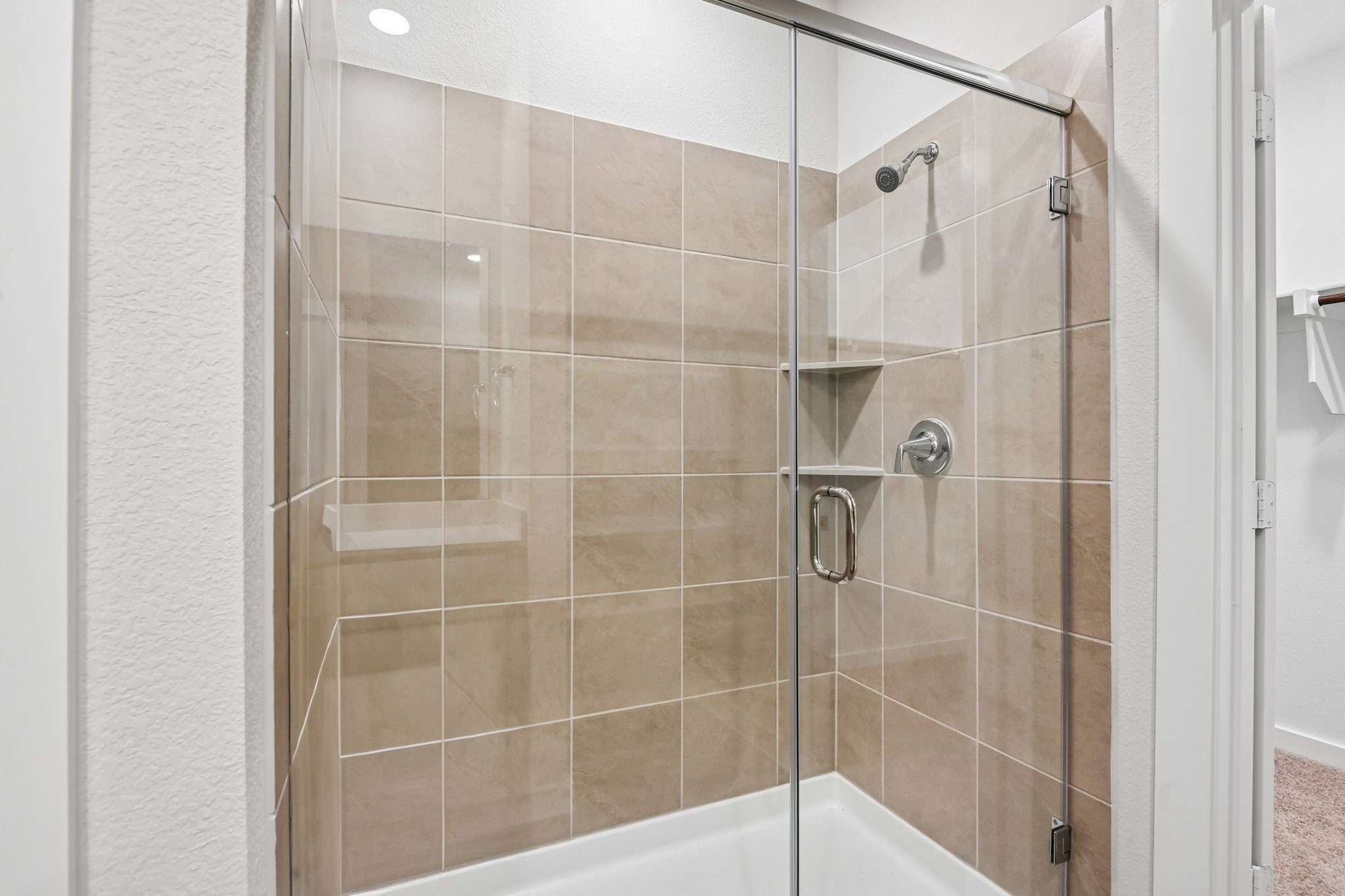 A shower with a glass door.