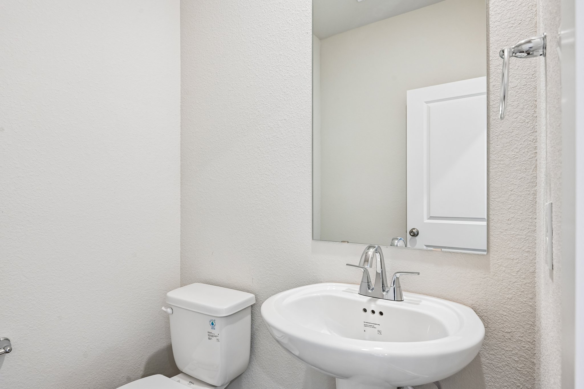 A bathroom with a toilet and sink.