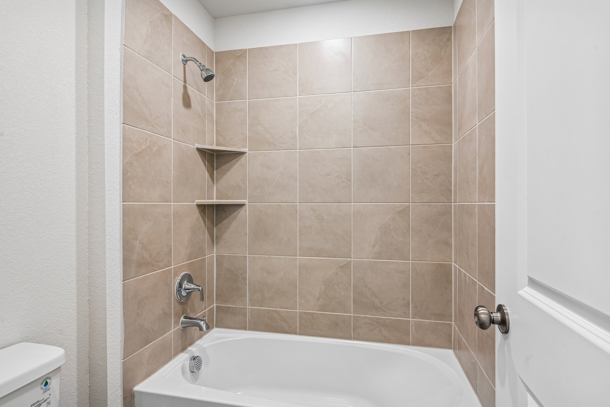 A bathtub in a bathroom.