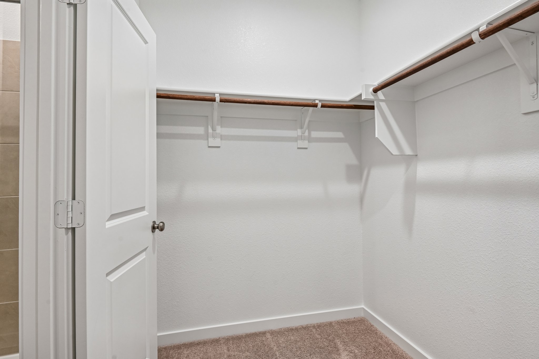A white staircase with a metal railing.