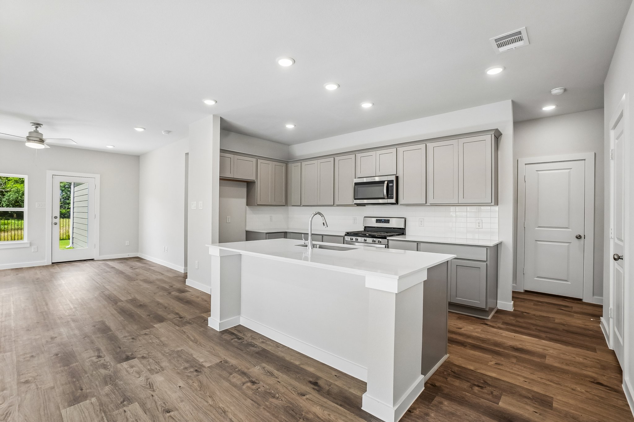 A kitchen with white cabinets.