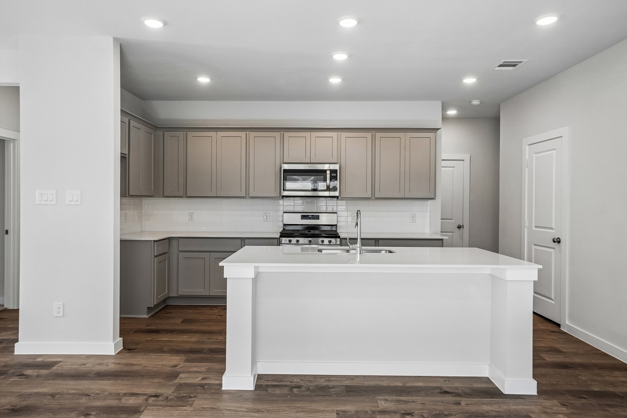 A kitchen with white cabinets.