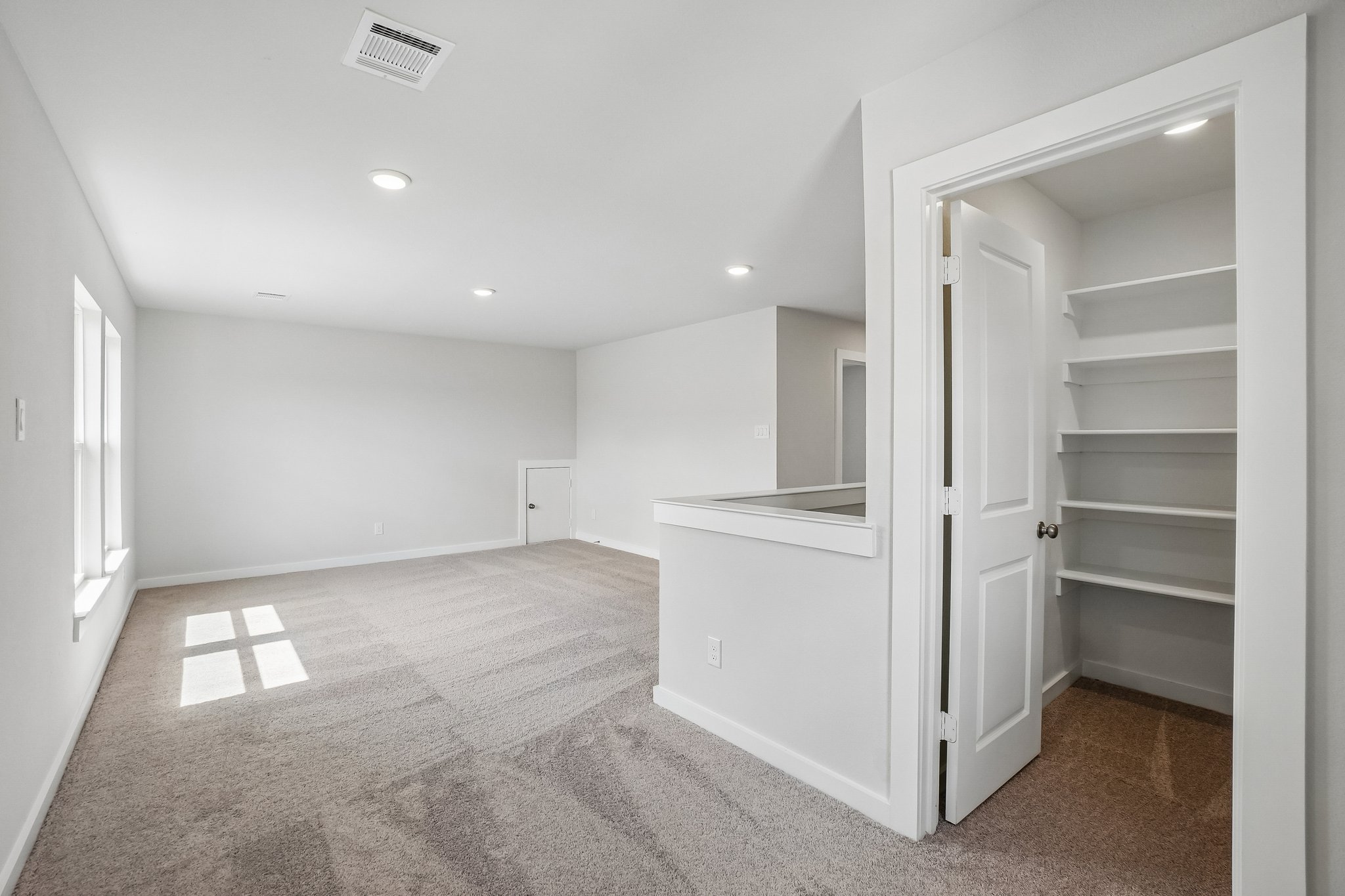 A room with white walls and a white cabinet.