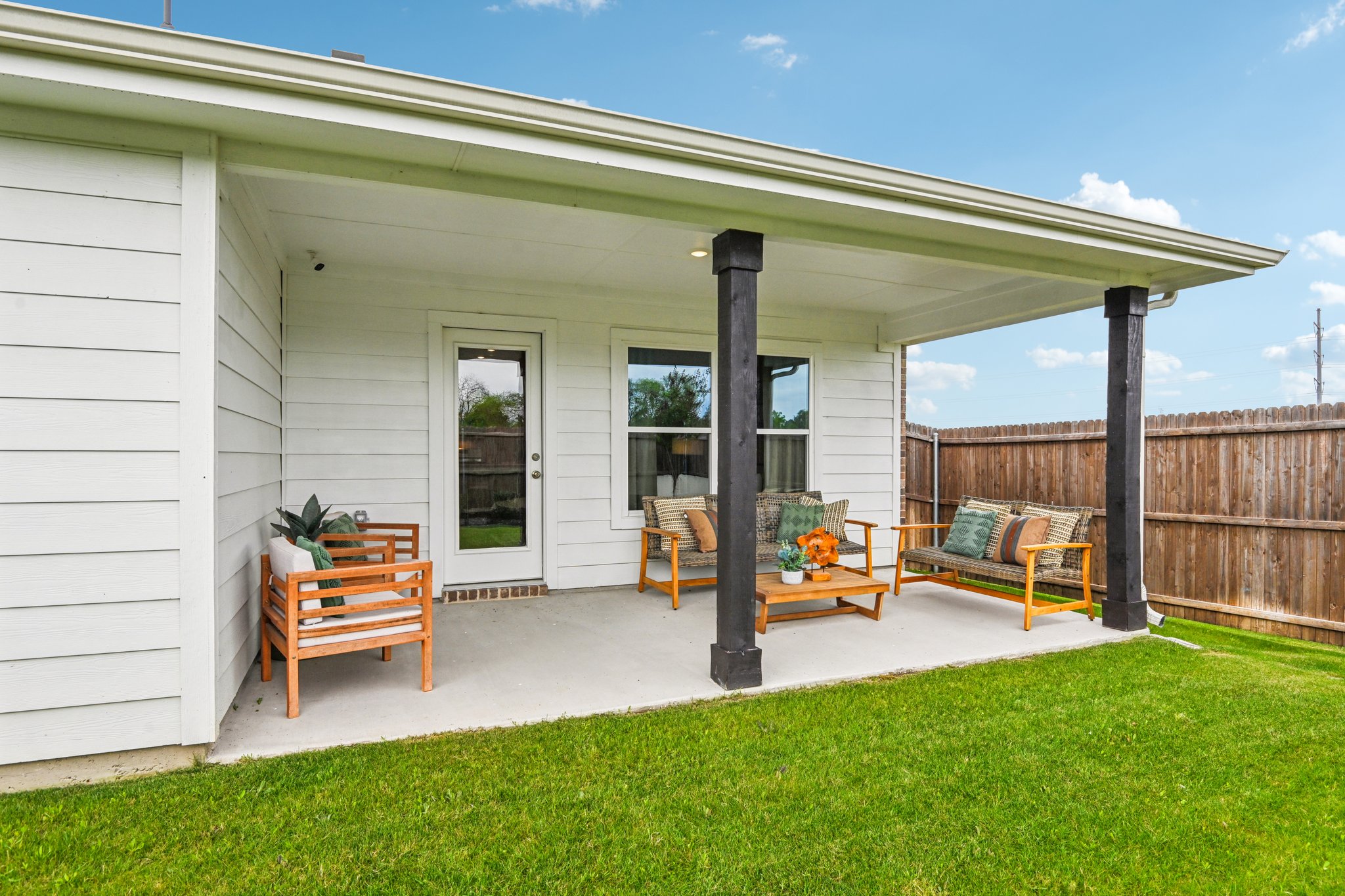 A house with a patio and a fence.