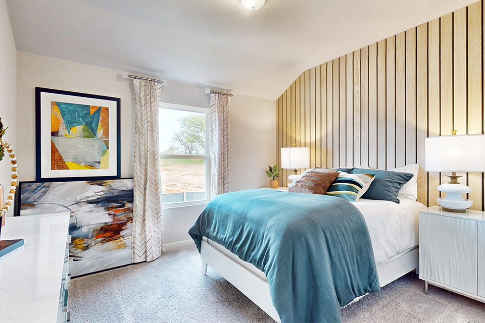 A bedroom with a large window.