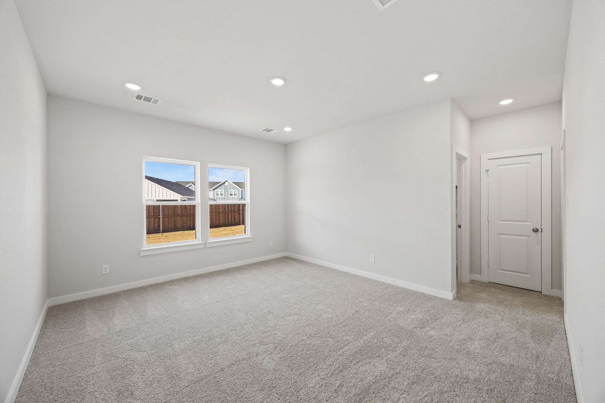 A room with white walls and a window.