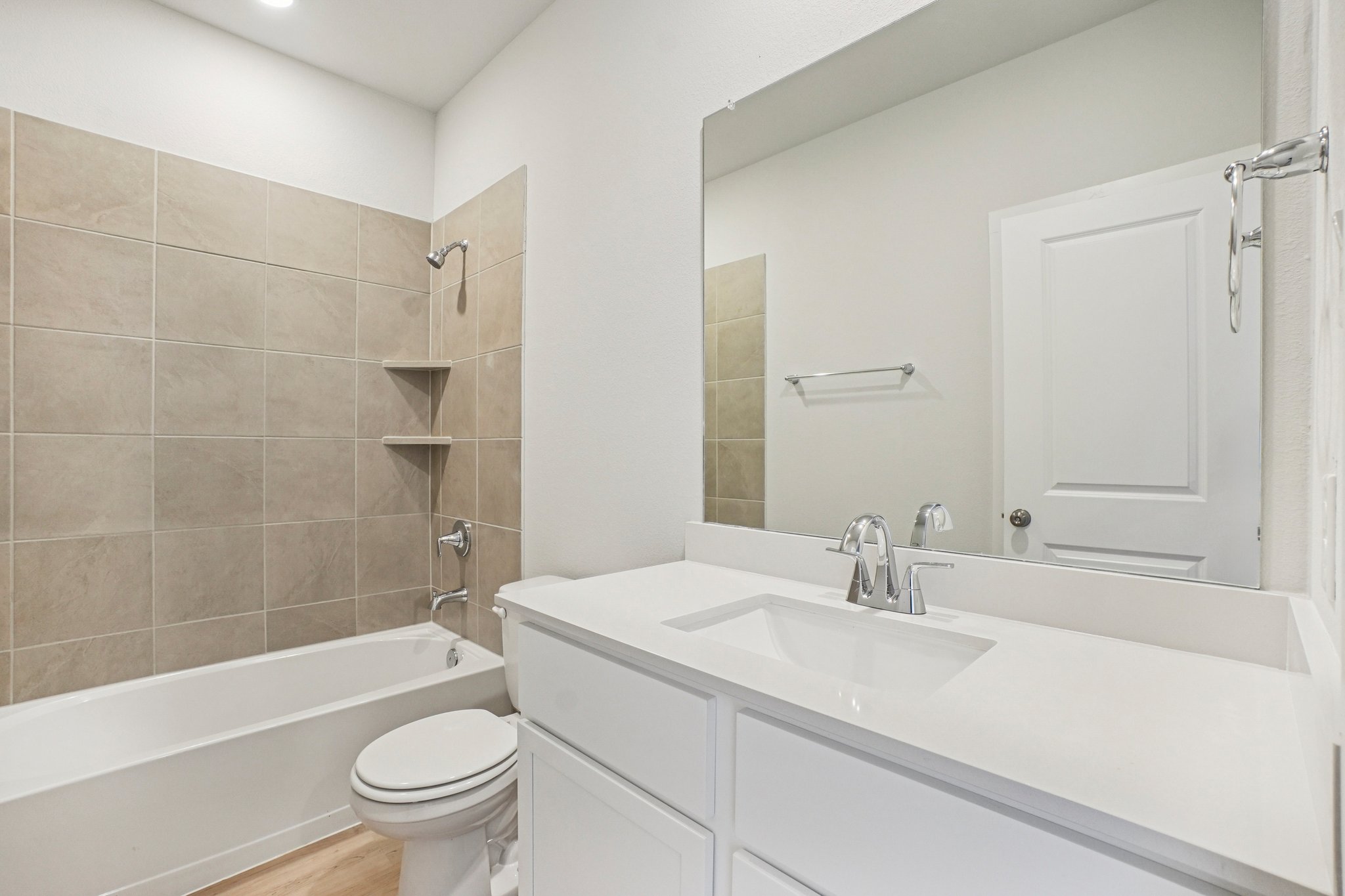A bathroom with a tub sink and toilet.