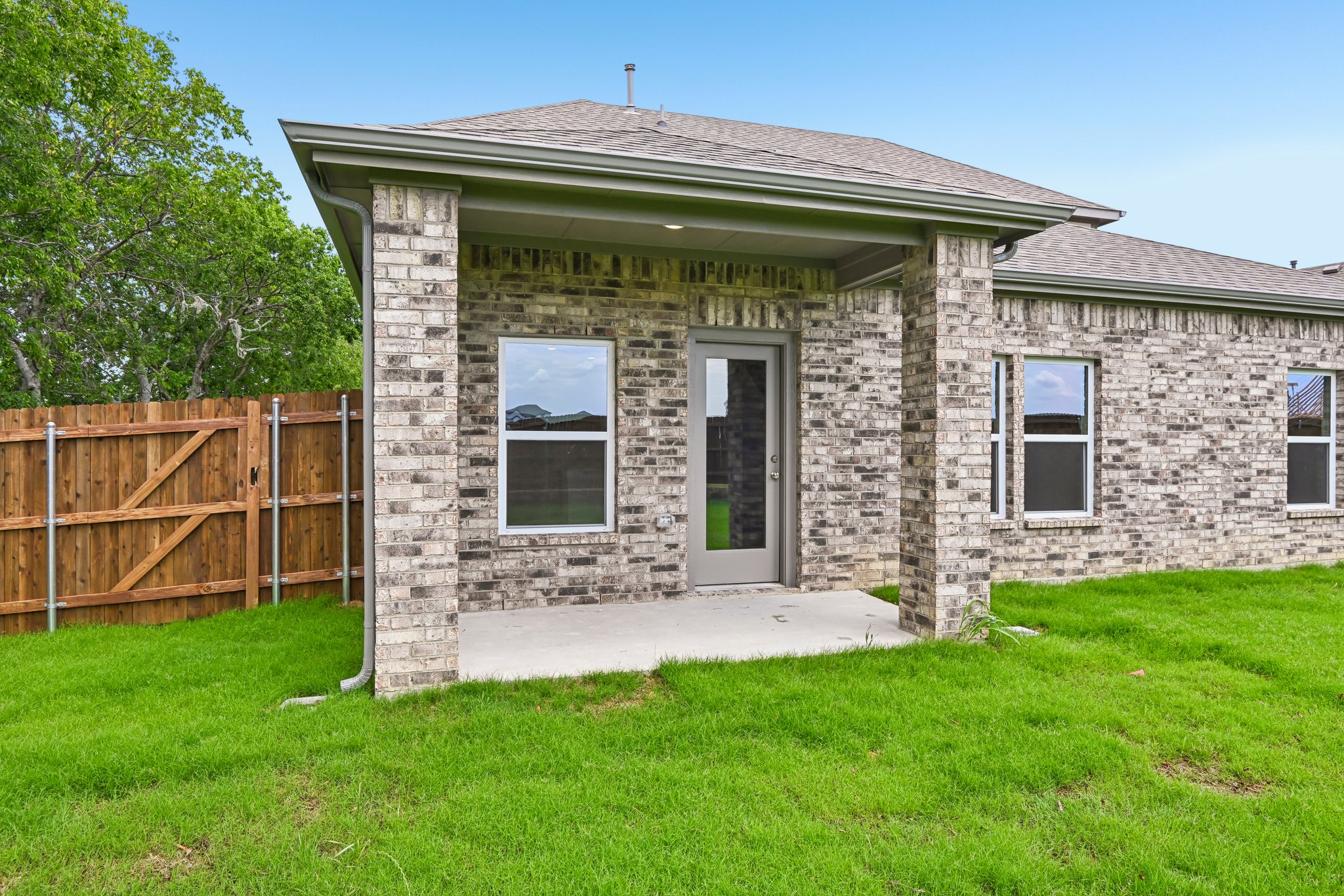 A stone house with a fence.