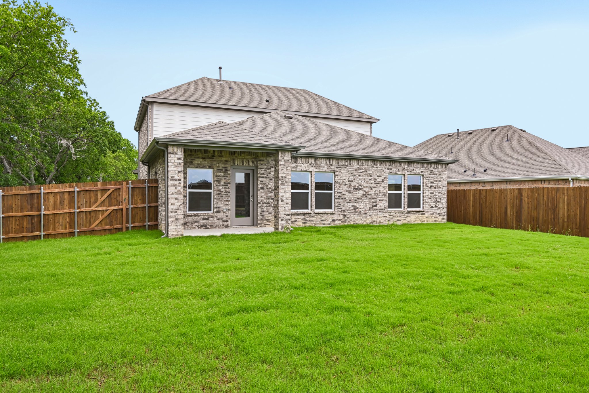 A house with a fence and grass.