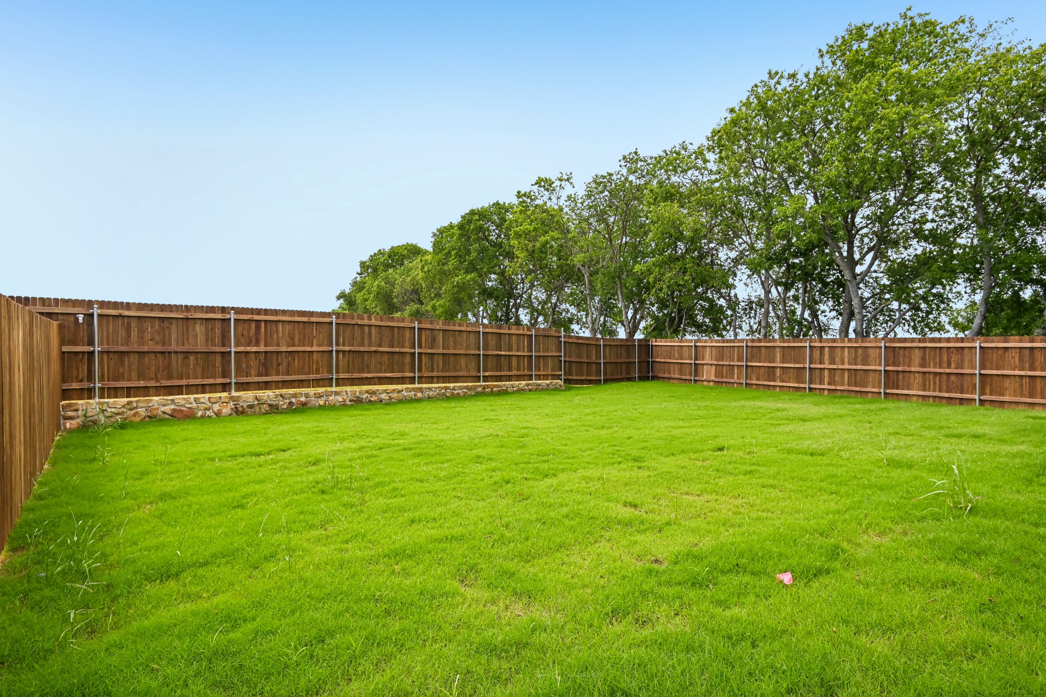 A fenced in grass field.