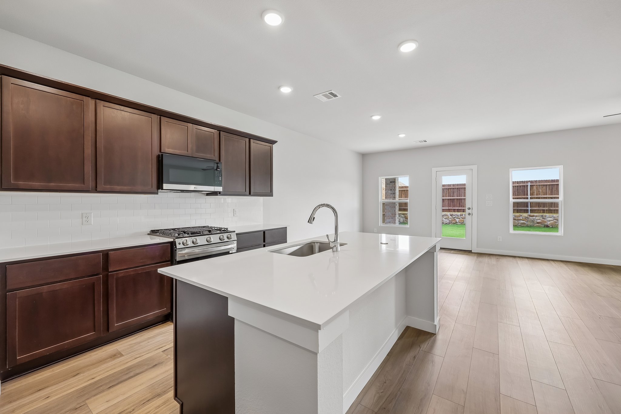 A kitchen with wooden cabinets.