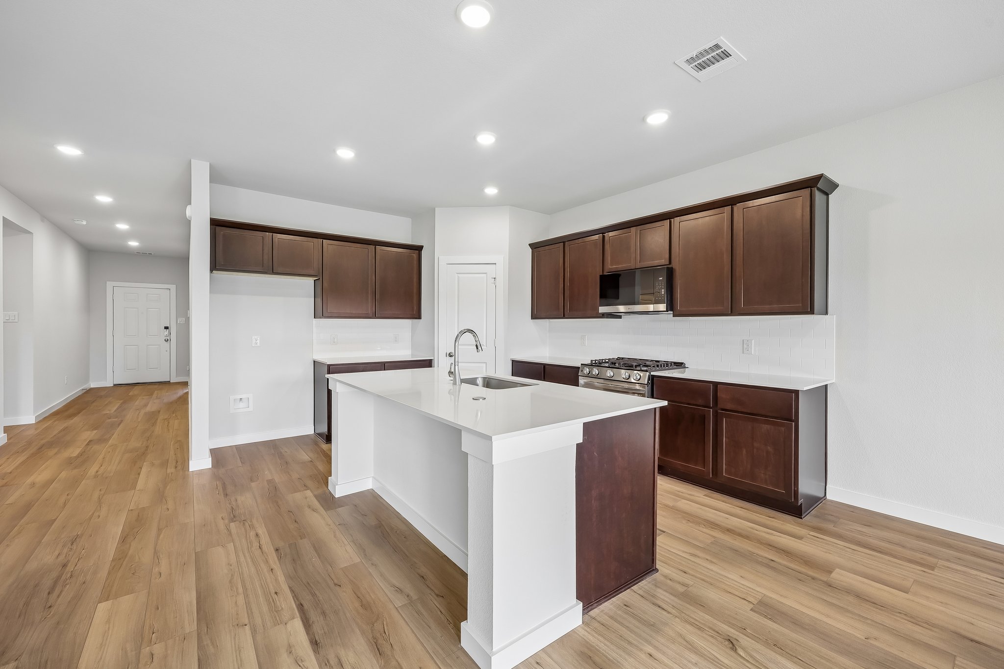 A kitchen with wooden cabinets.