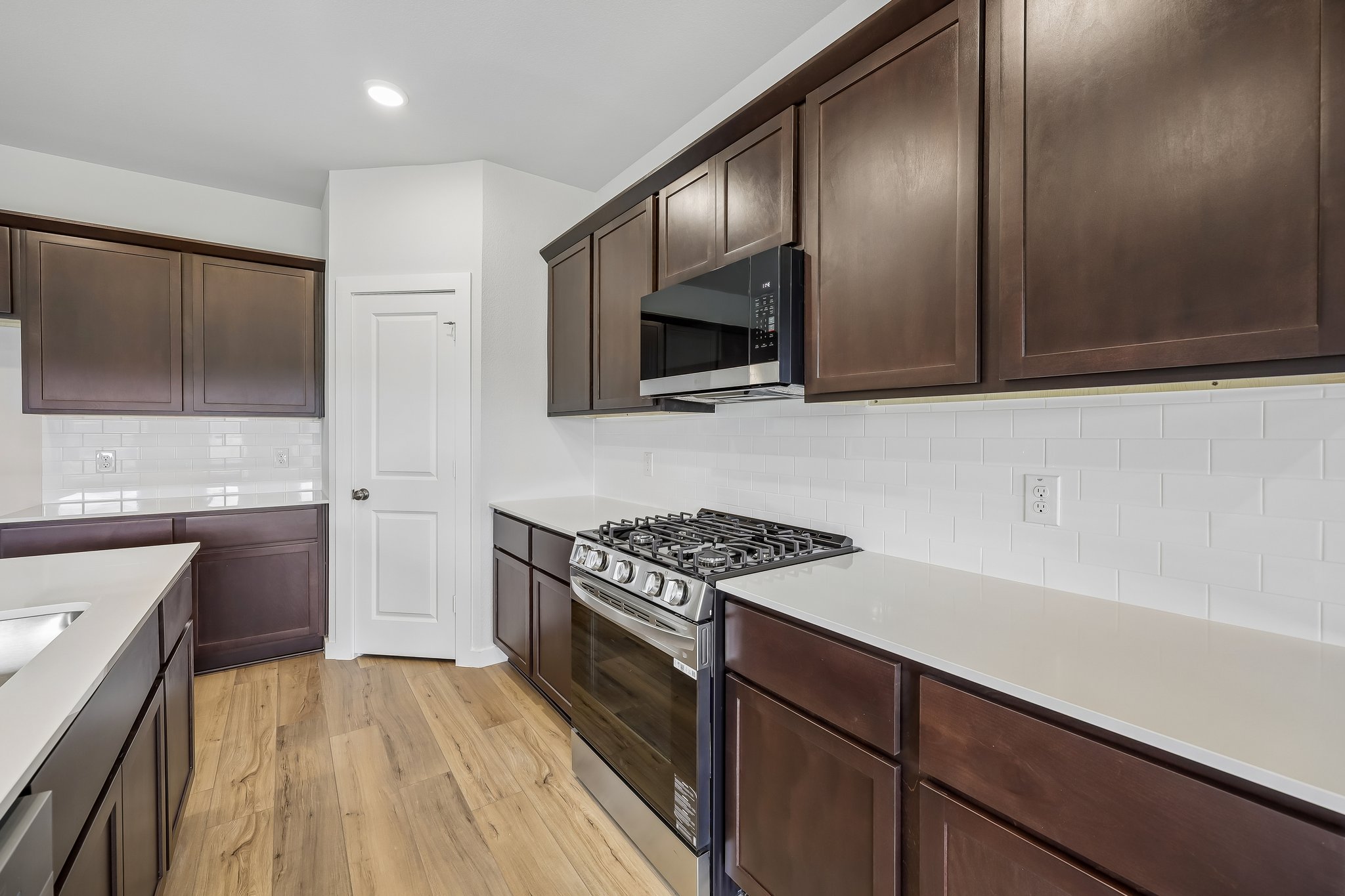A kitchen with wooden cabinets.