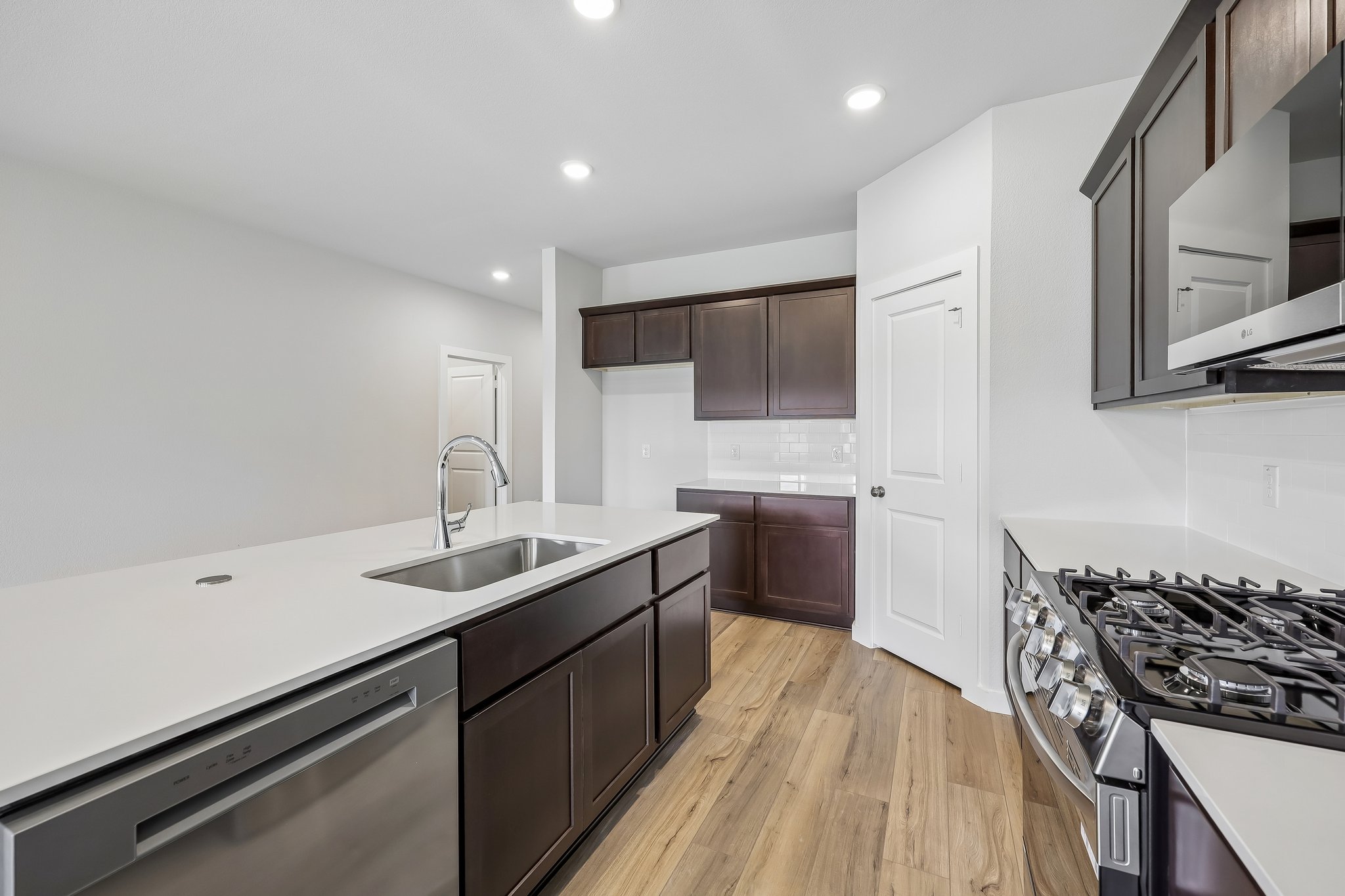 A kitchen with a wood floor.