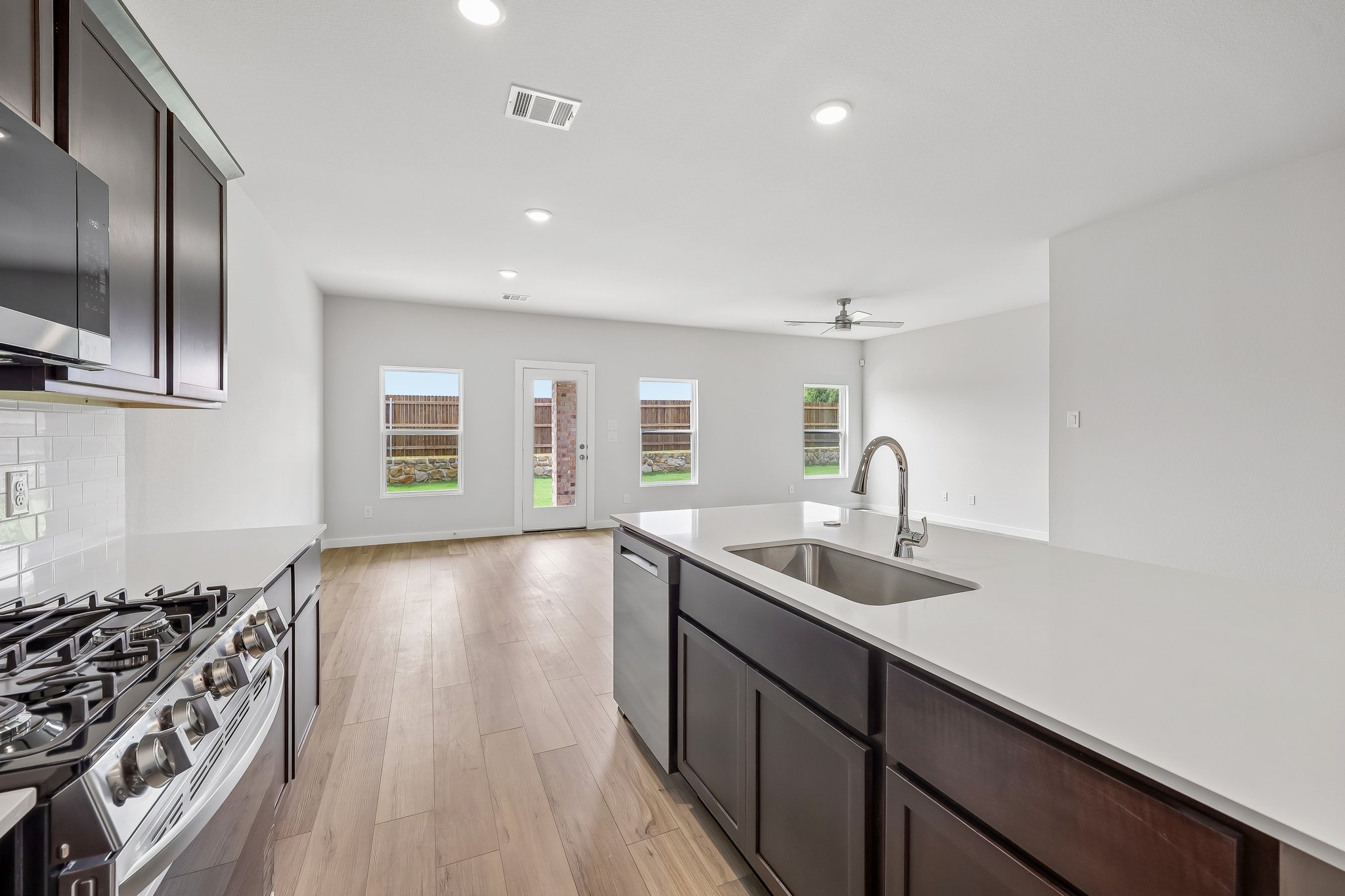 A kitchen with a wood floor.