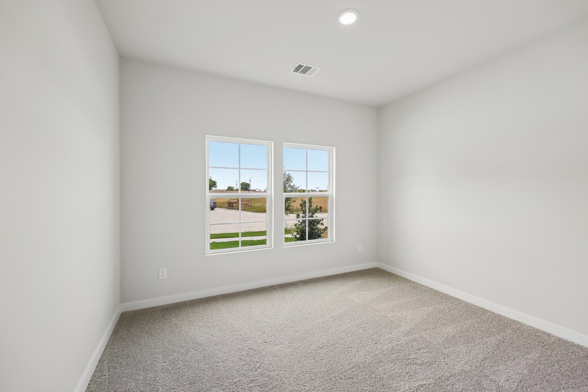 A room with a window and a carpet.
