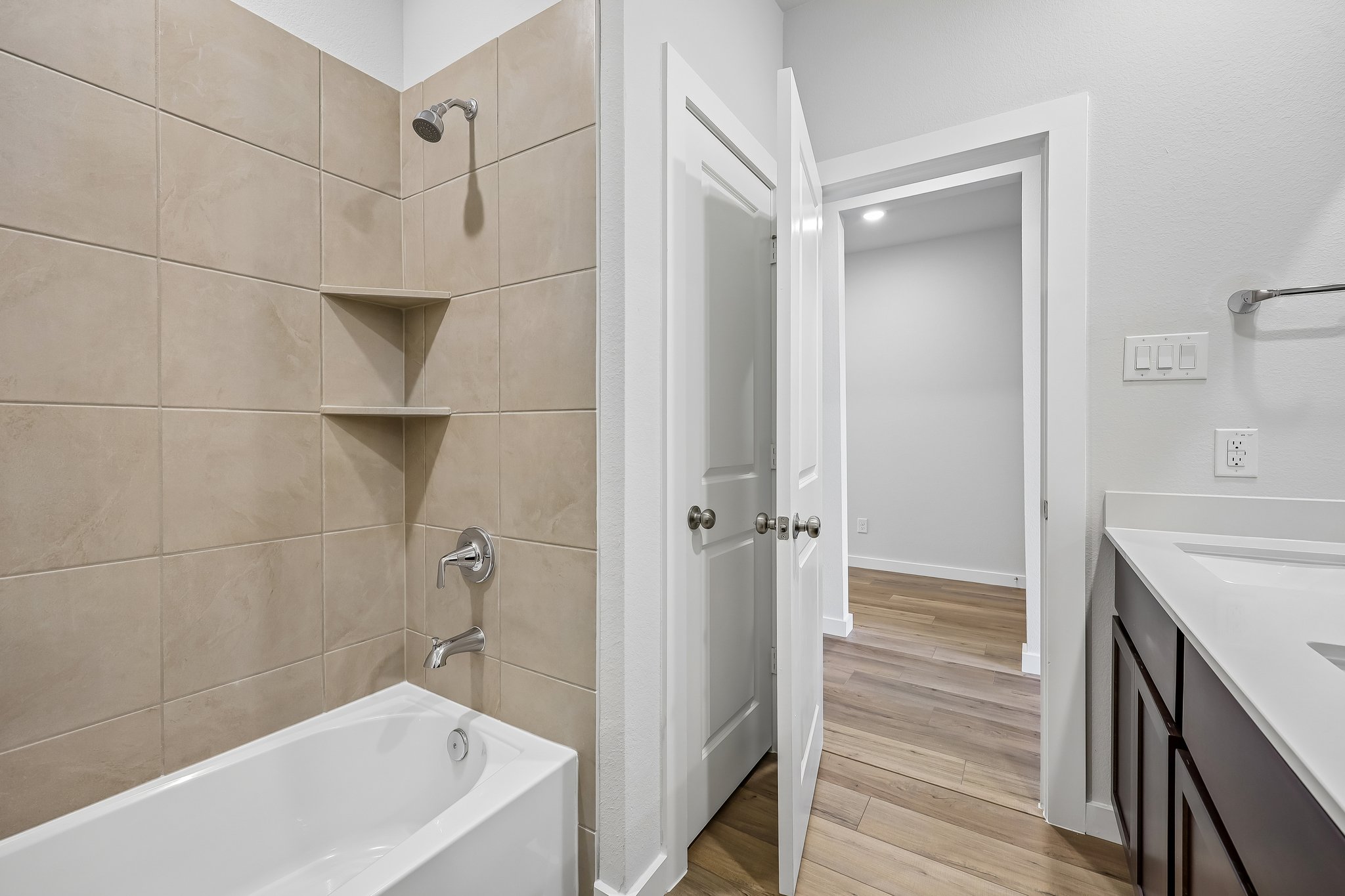 A bathroom with a tub and sink.