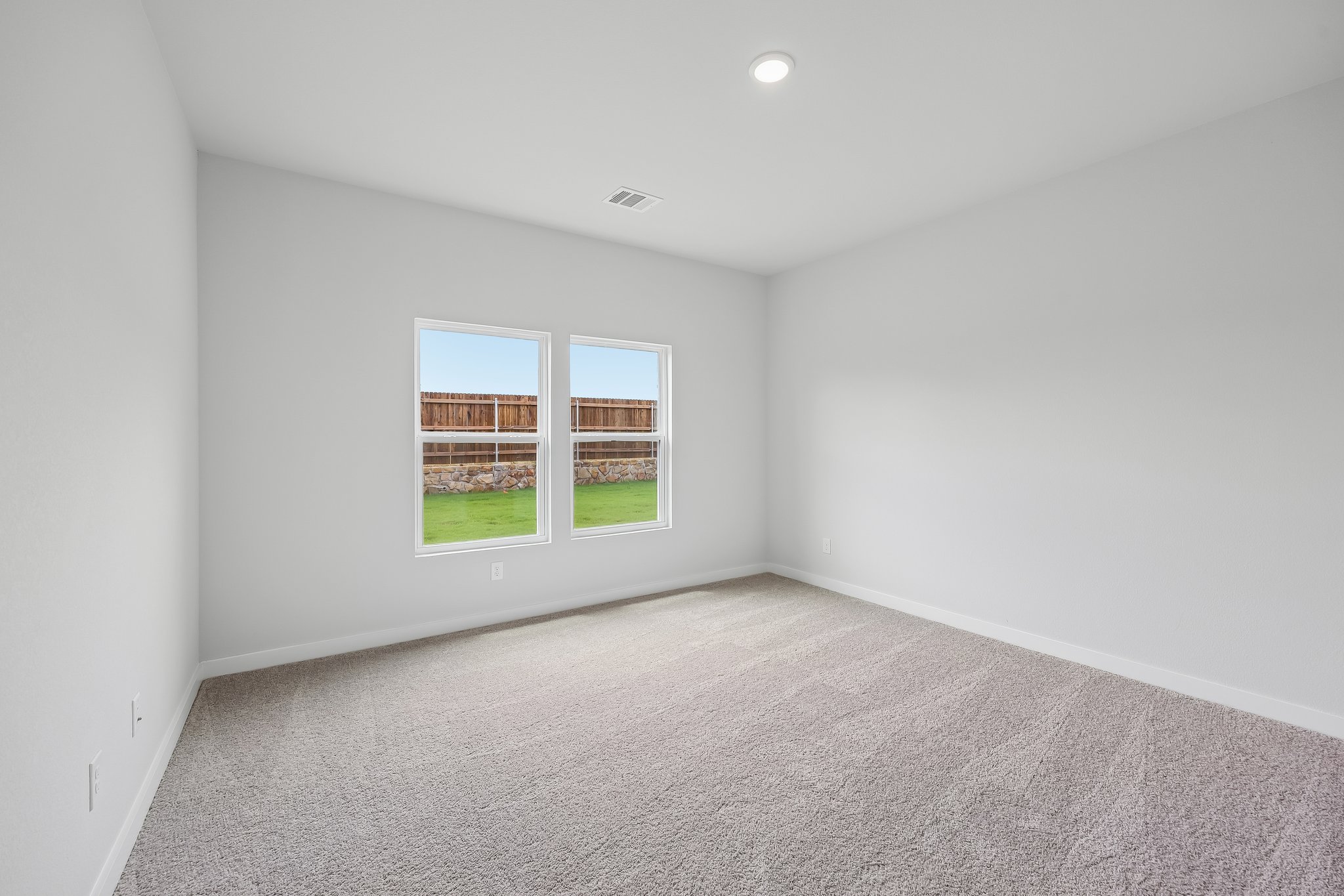 A room with a window and a carpet.