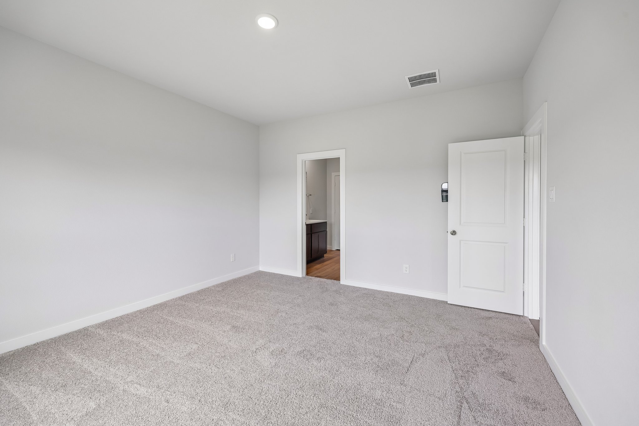 A hallway with white doors.
