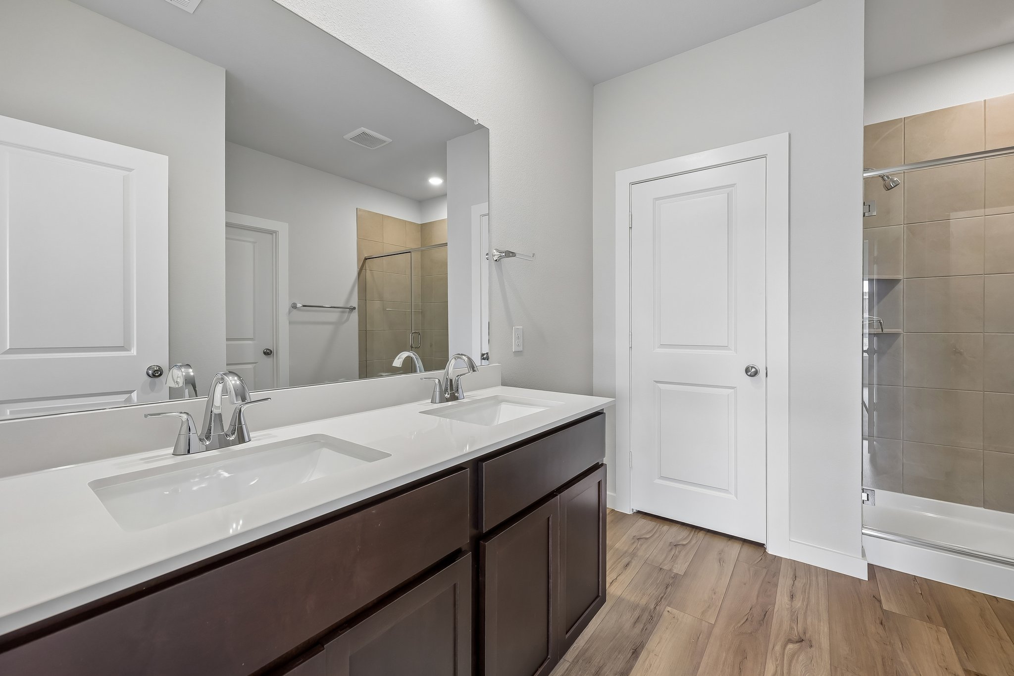 A bathroom with a large mirror.