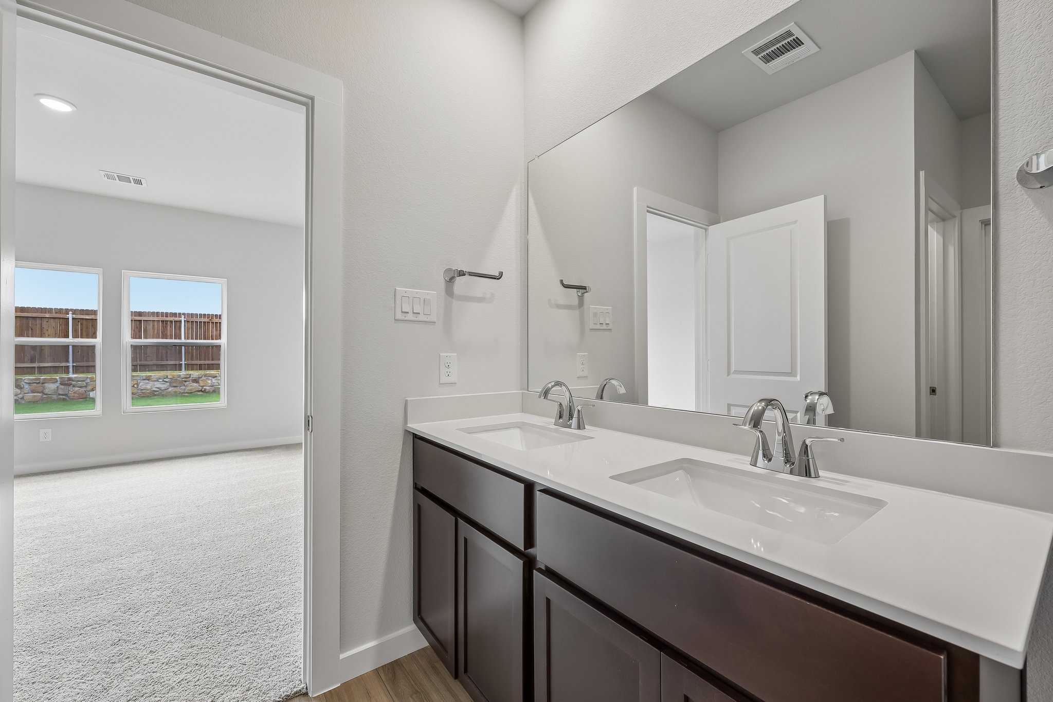 A bathroom with a large mirror.