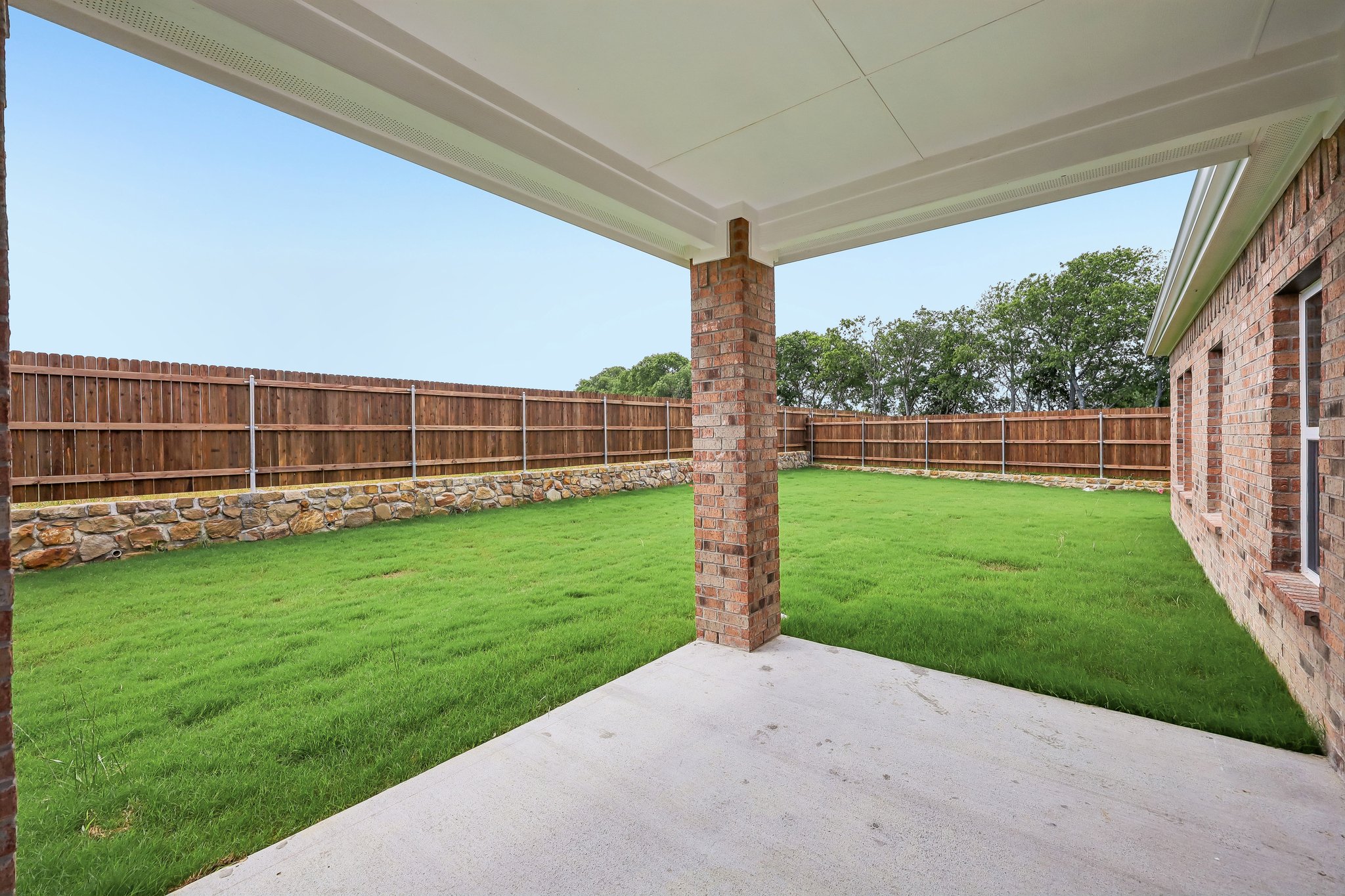 A brick chimney in a yard.