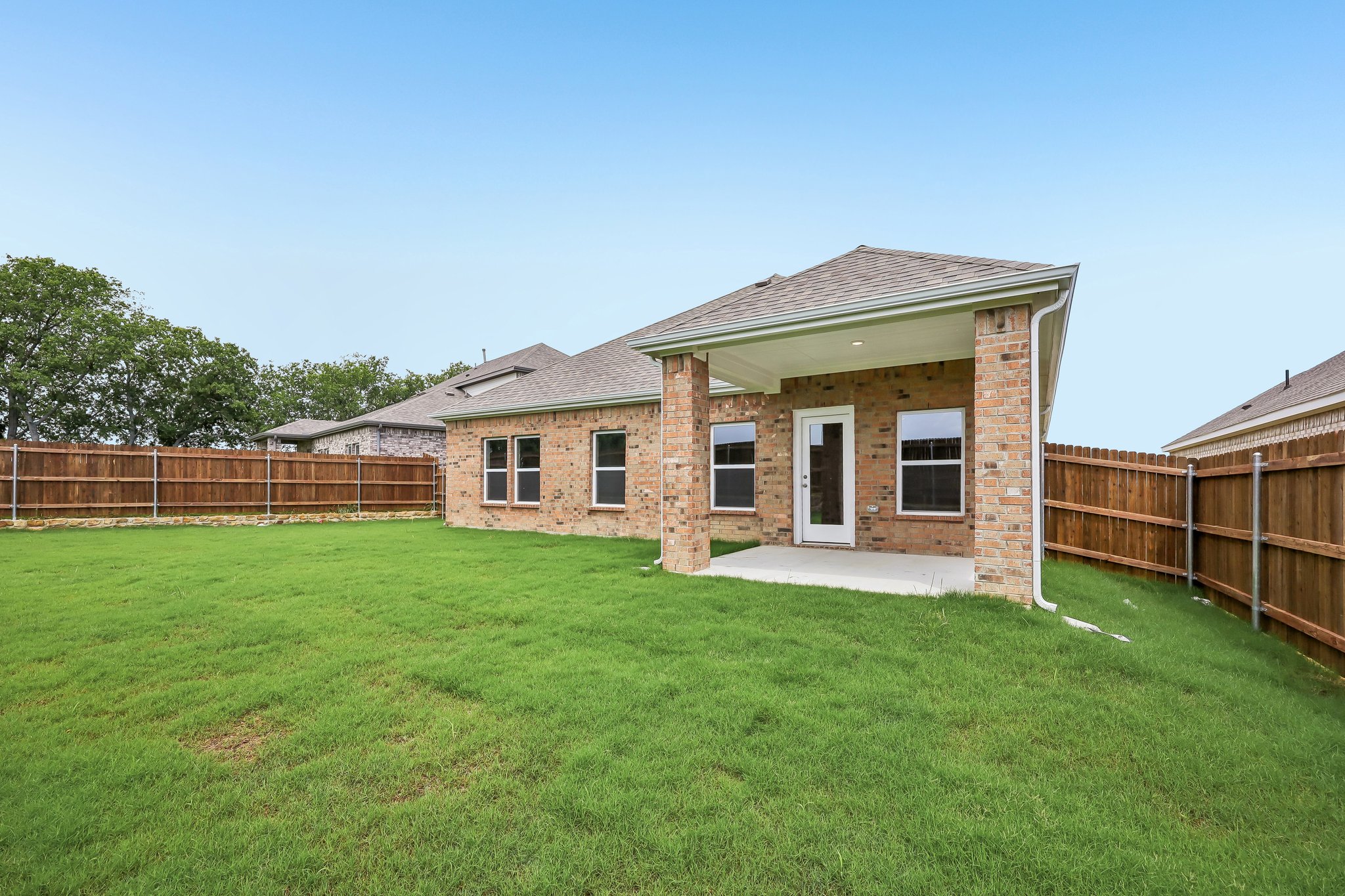 A brick house with a fence.