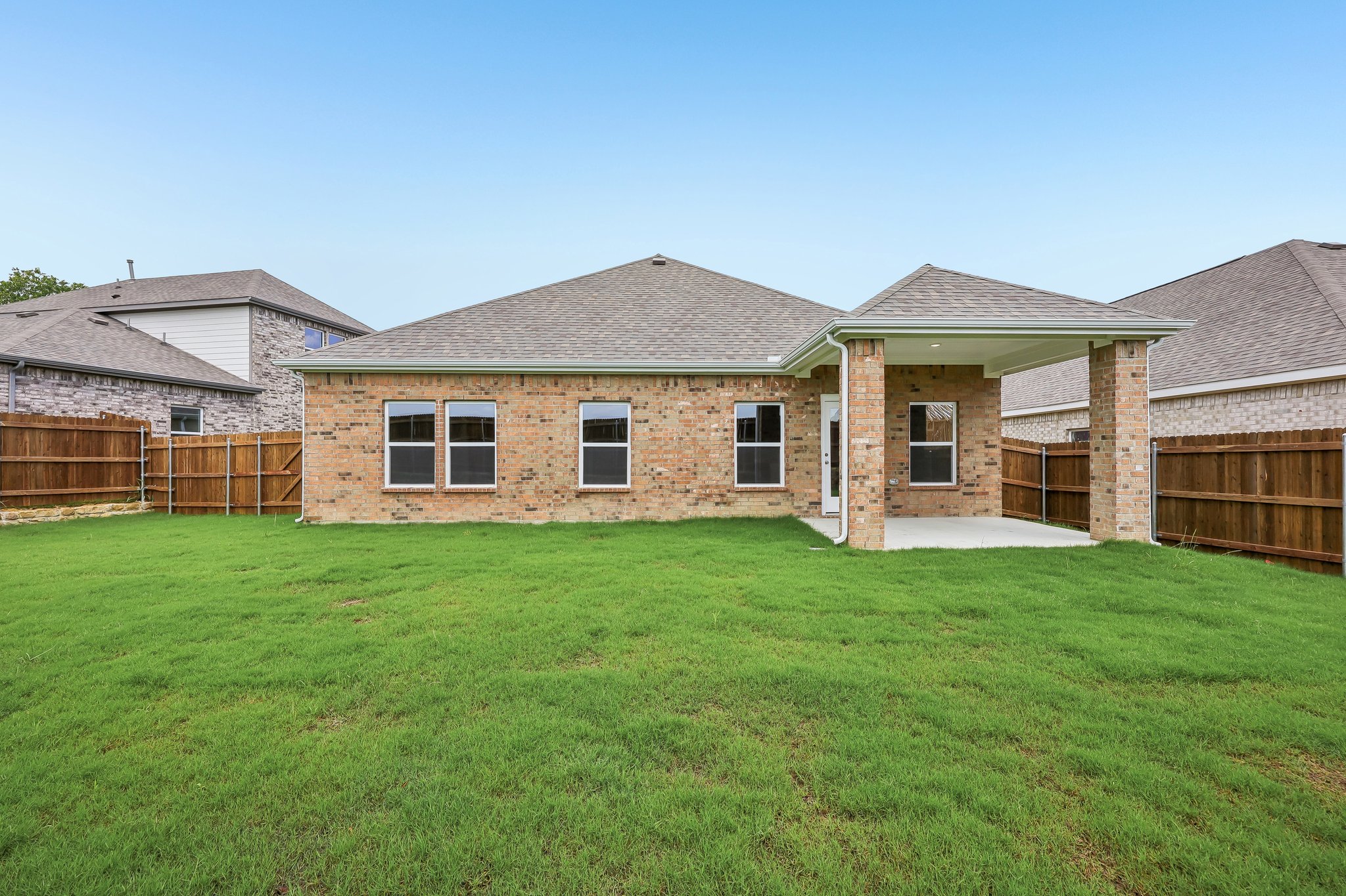 A house with a green lawn.