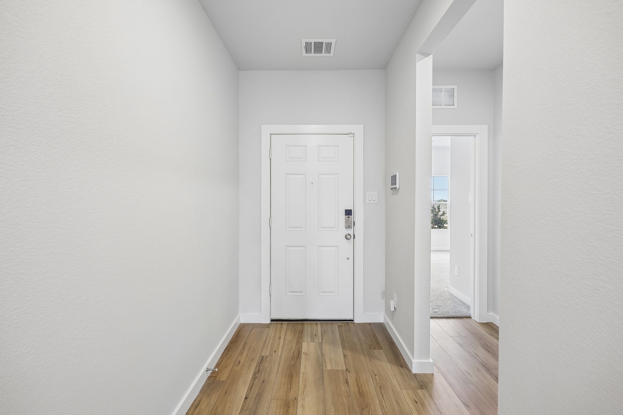 A hallway with white doors.