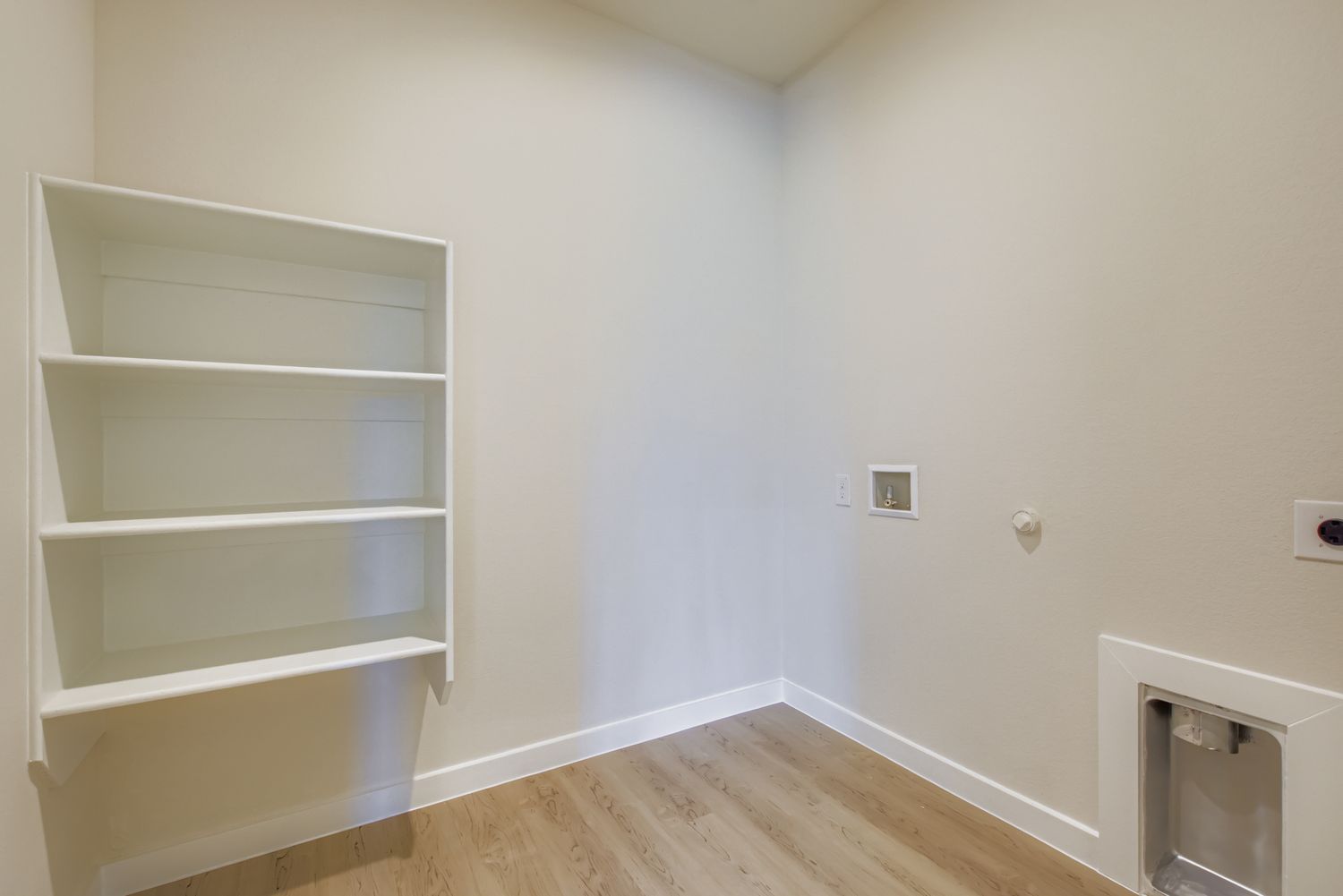 A white shelf in a room.