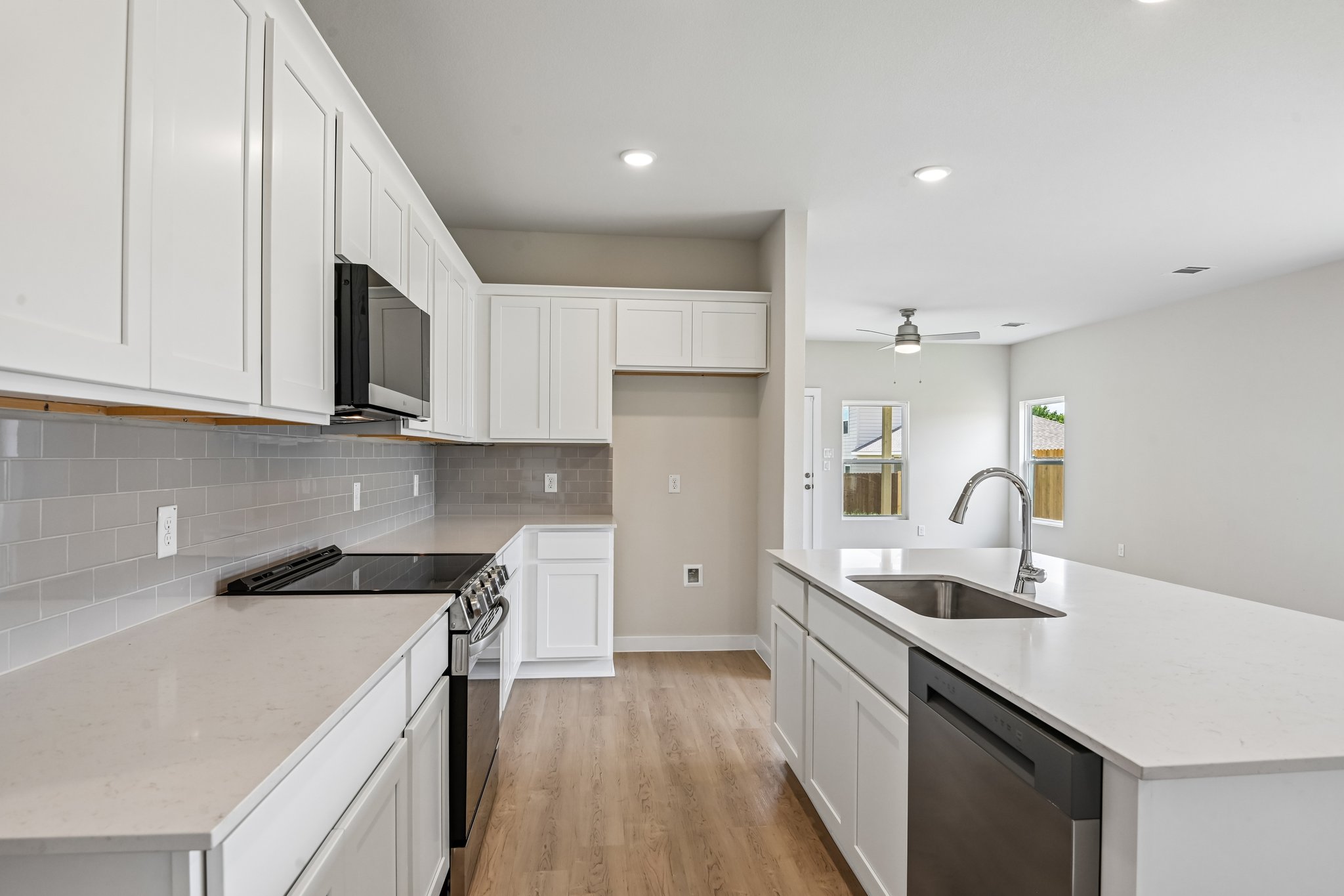 A kitchen with white cabinets.