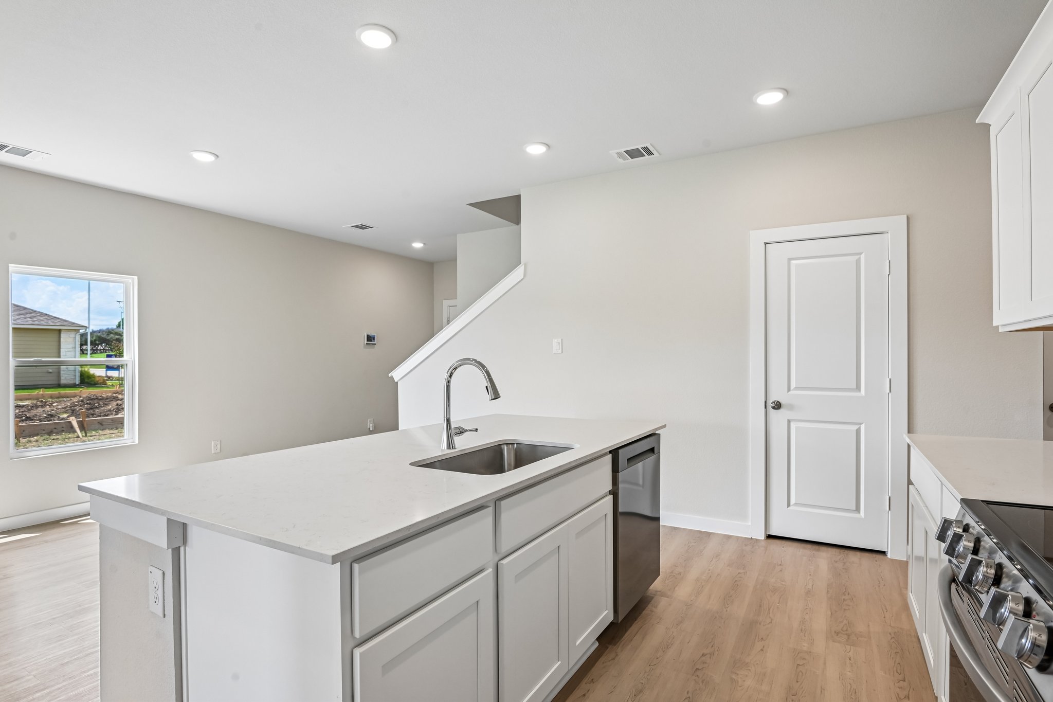 A kitchen with white cabinets.