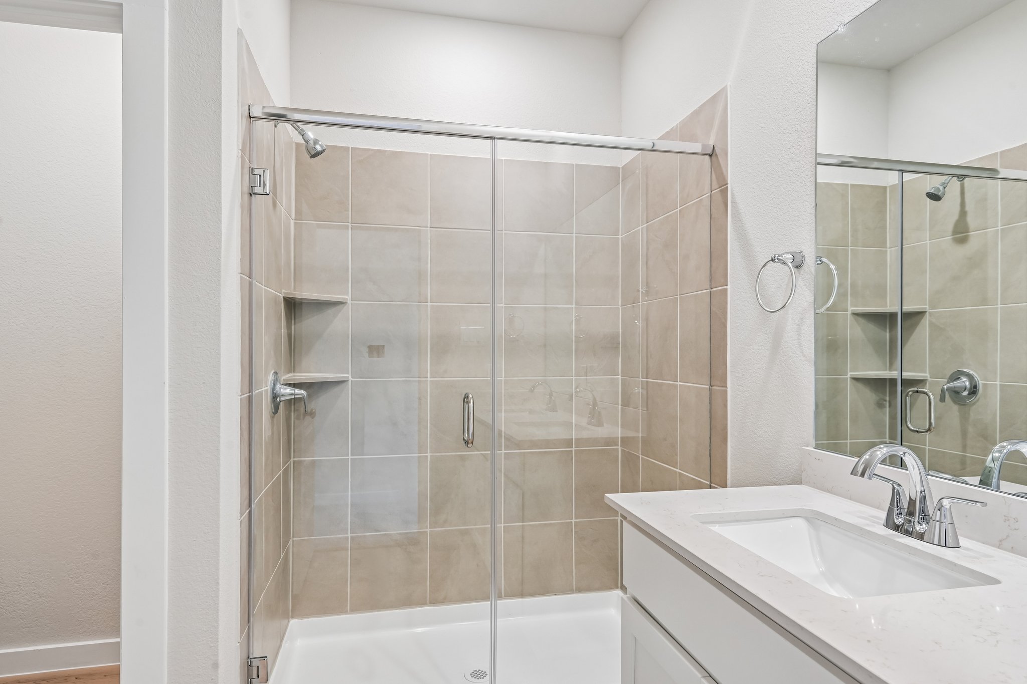 A bathroom with a glass shower.