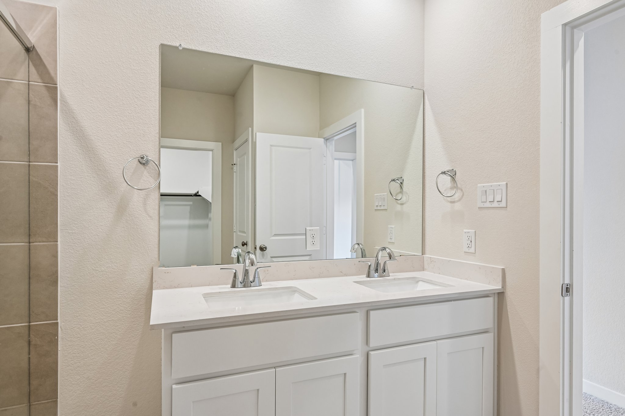 A bathroom with a large mirror.