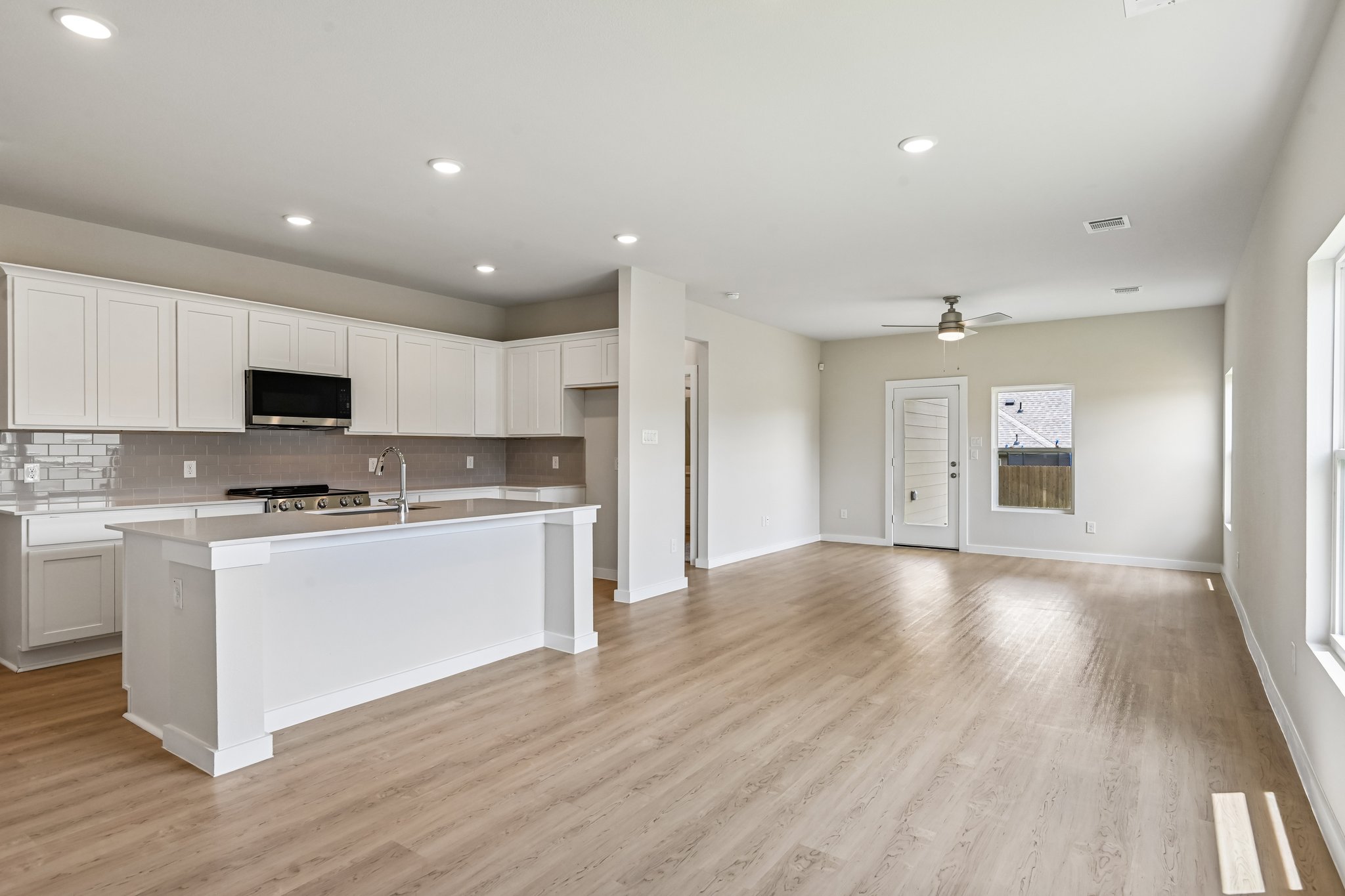 A large kitchen with white cabinets.