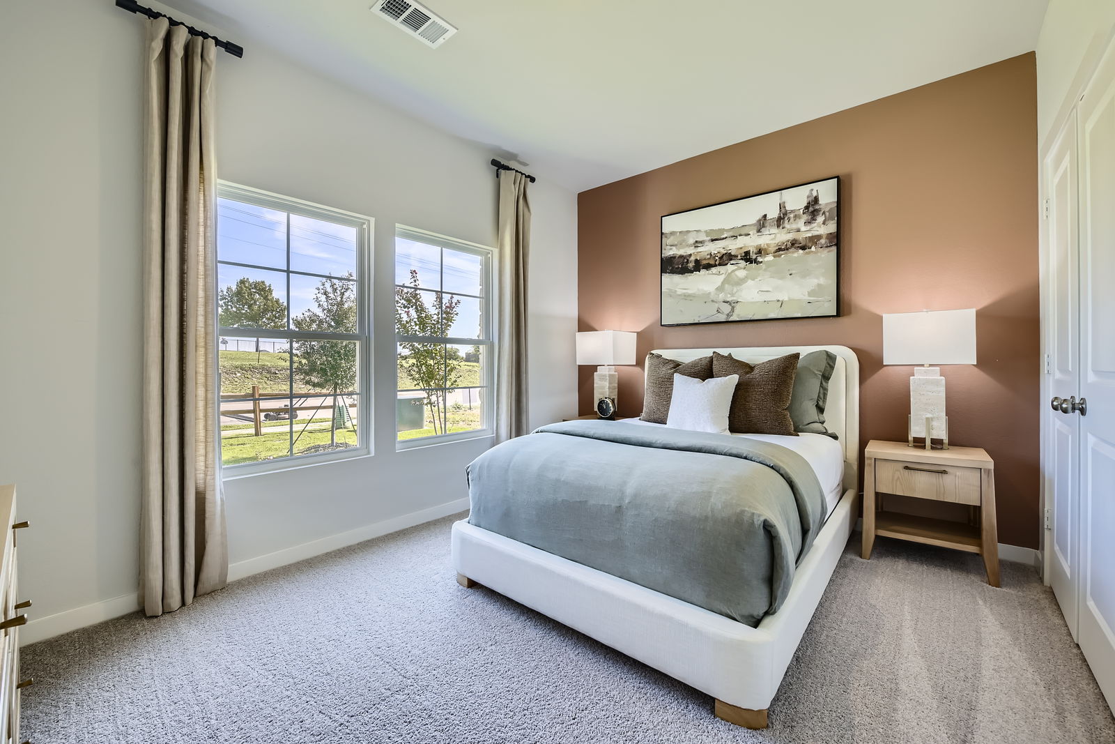 A bedroom with a large window.